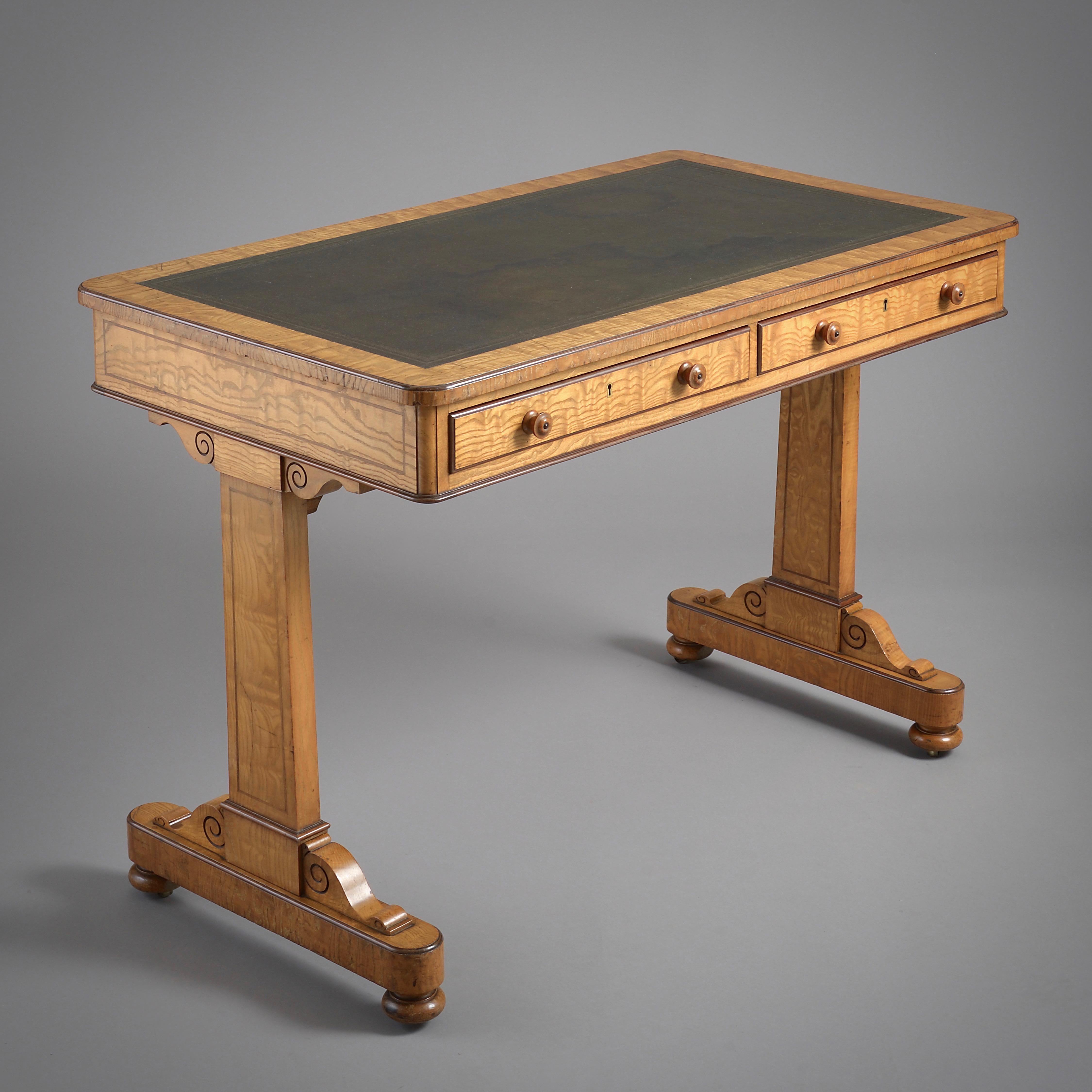 An early Victorian Hungarian ash and purpleheart writing-table attributed to Holland & Sons, circa 1850.

With original gilt-tooled green leather top, the frieze fitted with two mahogany-lined drawers.
