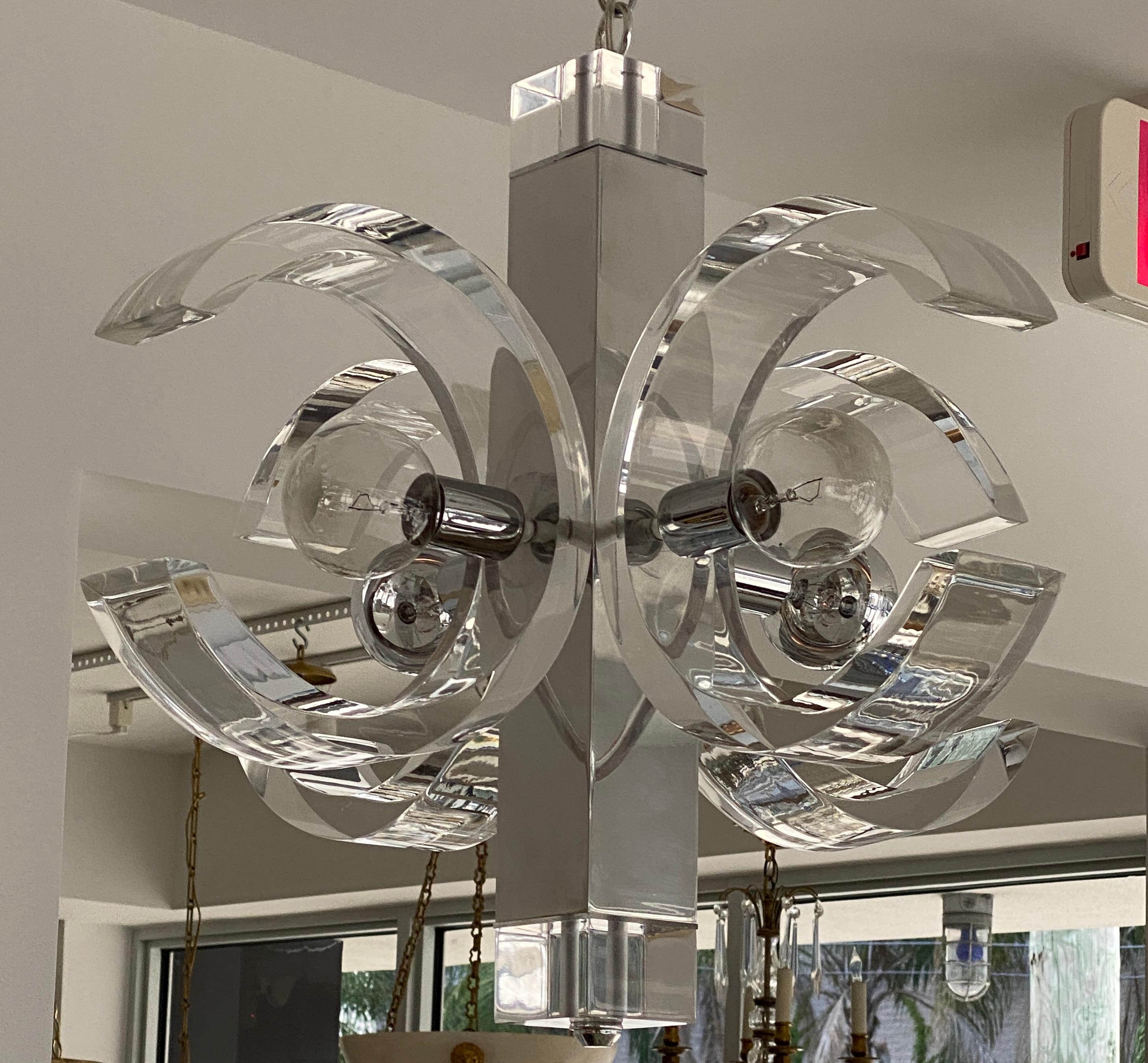 This stylish and chic 1970s lucite and aluminum chandelier is by Charles Hollis Jones and it will make a definite statement with its 