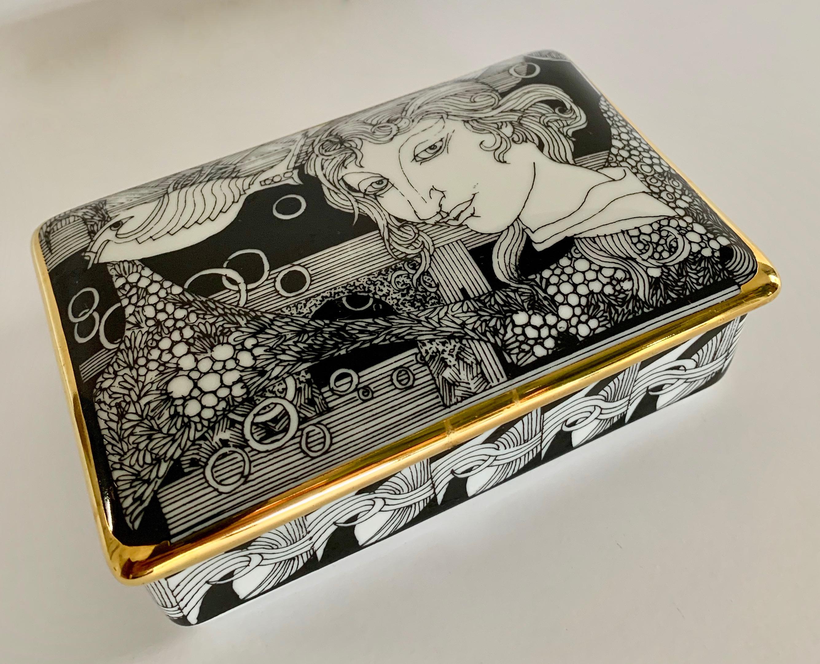 Hollohaza hand painted gilt porcelain lidded box - a lovely box with a unique and detailed modern image – 21-karat gilt hand painted piece. Very much like those by Pierro Fornasetti and ready to give your cocktail table or desk a wonderful exciting