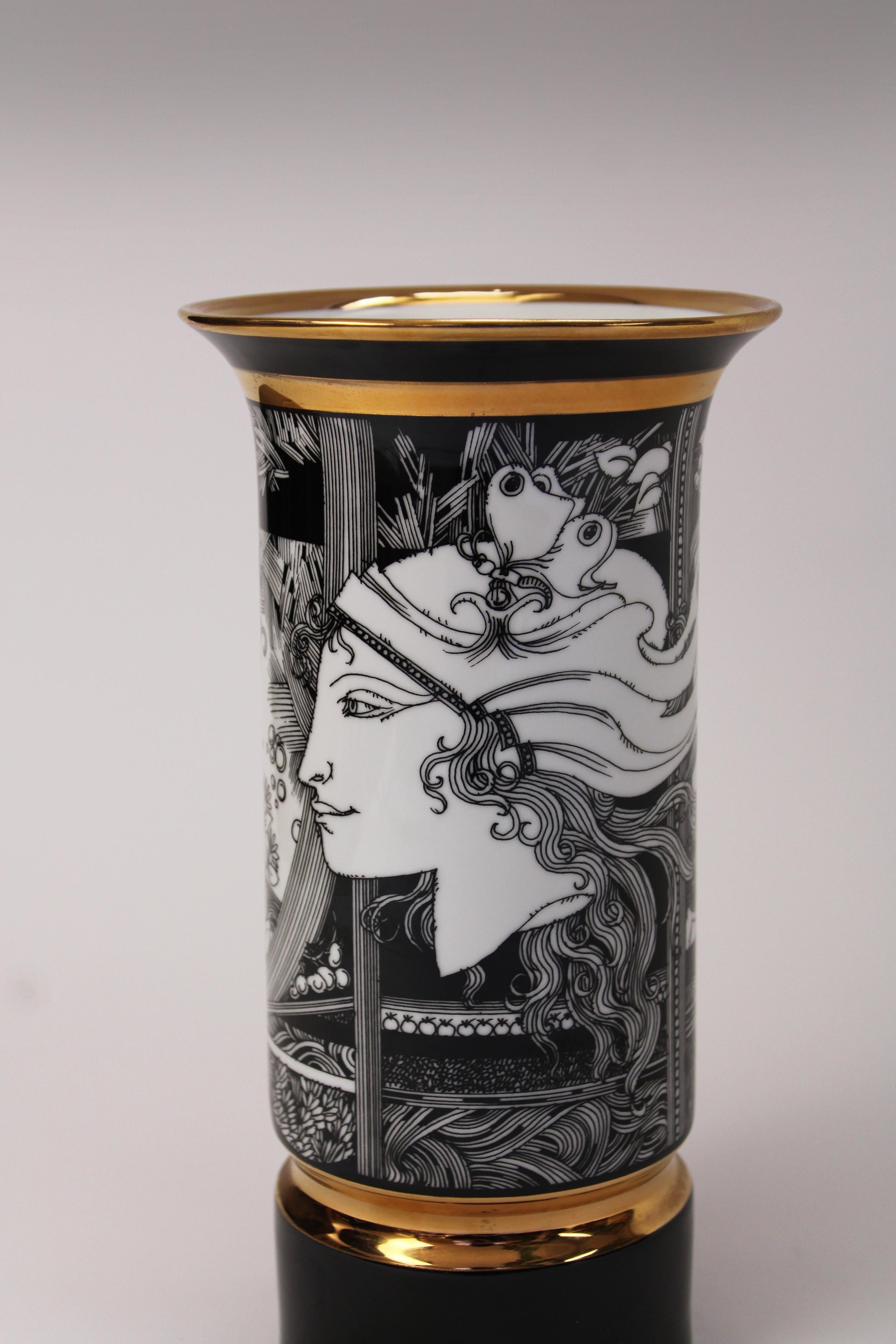 Introducing an exquisite Hollohaza Porcelain Vase, crafted in the mid-century modern style by the renowned Hungarian artist Endre Szász. This cylindrical vase features a captivating illustration of women and butterflies in striking black and gold