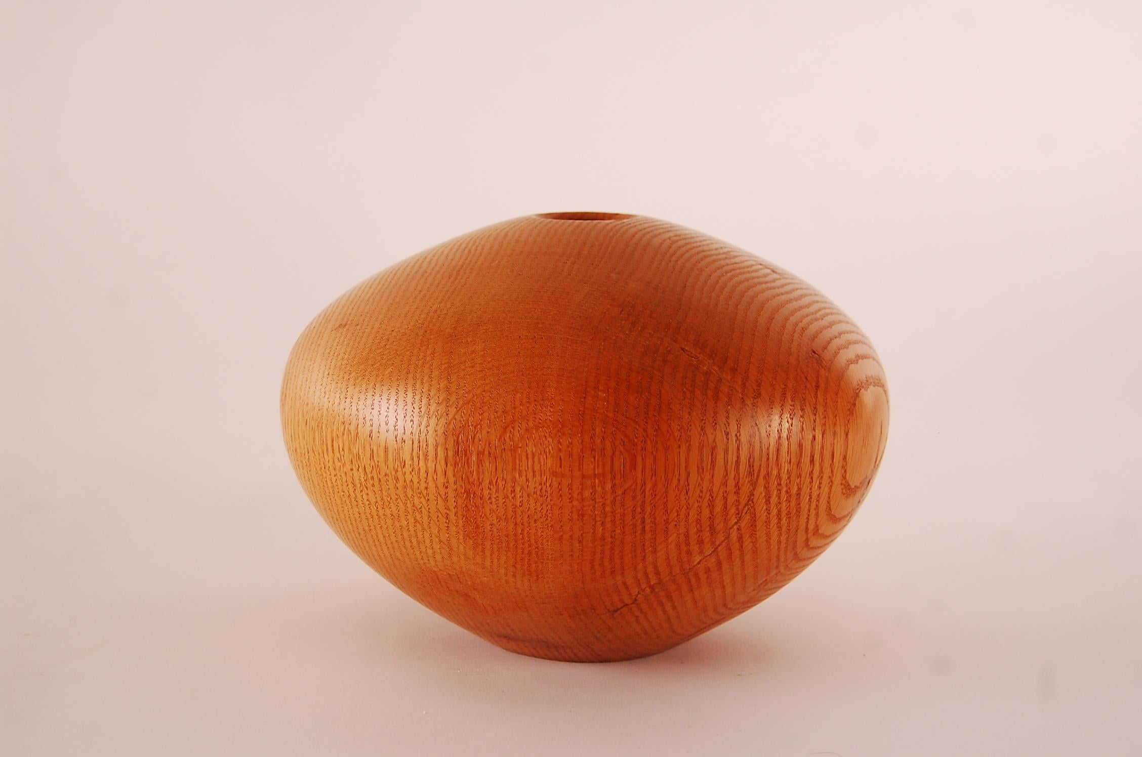 Beautiful hollow form vase in red oak, by master wood-turner Ron Pessolano, circa 1990.