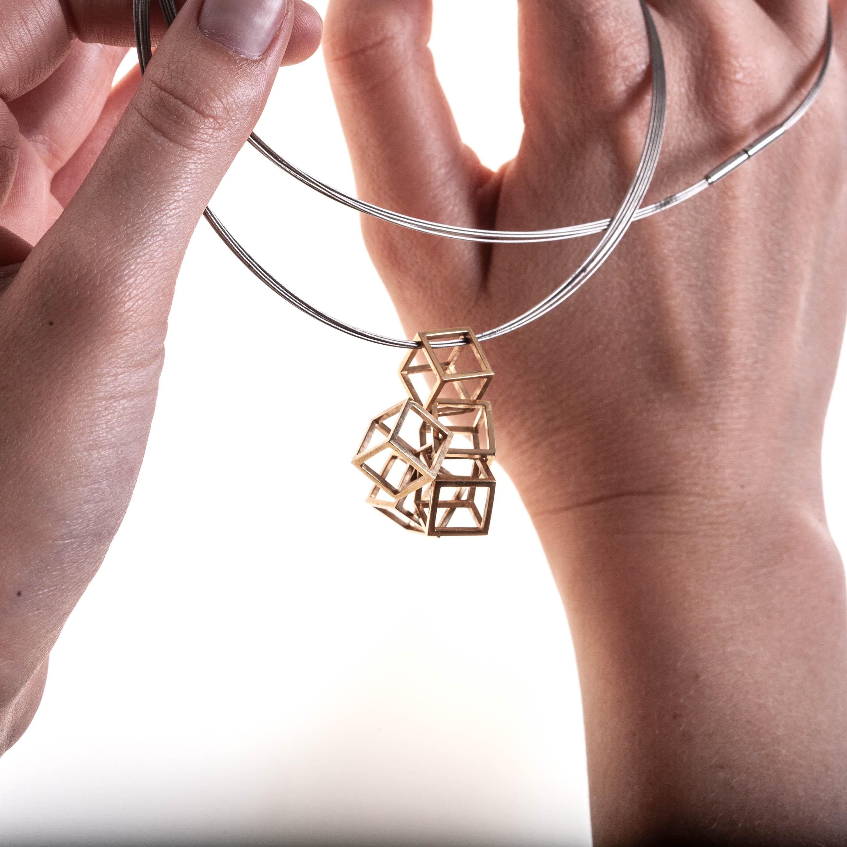 6 Hollow Geometric Cubes Statement Pendant 18K Gold, on a Stainless Steel Coil

This Cubes Pendant is for a sophisticated woman. It contains 6 geometric cubes  made in 18k gold. 
A beautiful statement pendant set on Stainless Steel coil , Modern and