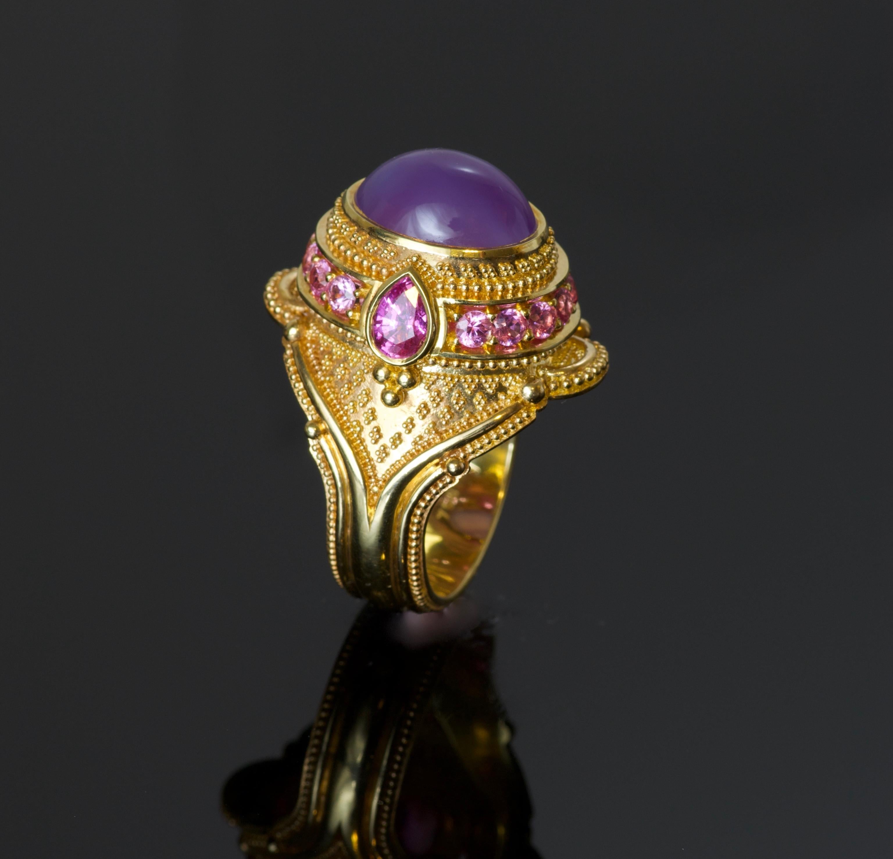 This one of a kind cocktail ring created by master goldsmith Kent Raible, features a Natural Oregon Holly Agate (5.39 carats) cabochon cut center gemstone, surrounded by Pink Sapphires (2.28 carat total weight), all set in 18  karat Gold (19.6