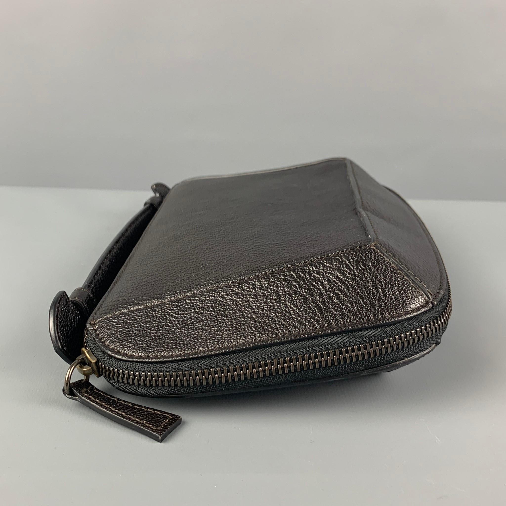 HOLLY CARDWELL clutch comes in a black leather featuring a red interior, top handles, inner slots, and a zipper closure. Made in Italy. 

Very Good Pre-Owned Condition.

Measurements:

Length: 10 in.
Width: 3 in.
Height: 4.5 in.
 