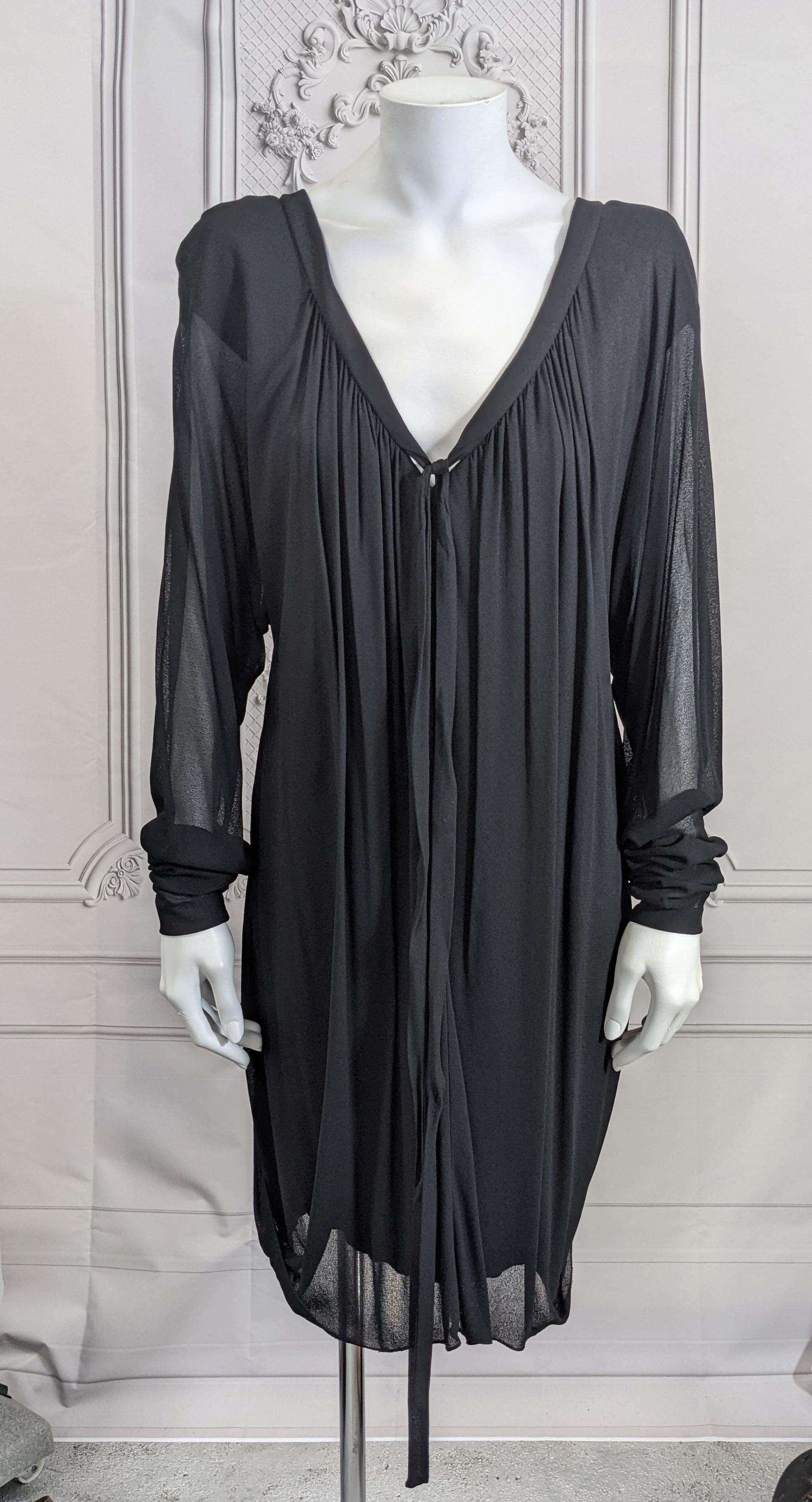 Holly Harp's Innovative Black Jersey Draped Mini from the late 1970's. Semi sheer jersey is gathered up into the back neckline from a balloon hem. Deep V neckline with long ties in front. There is a cap sleeved liner of rayon jersey within so only