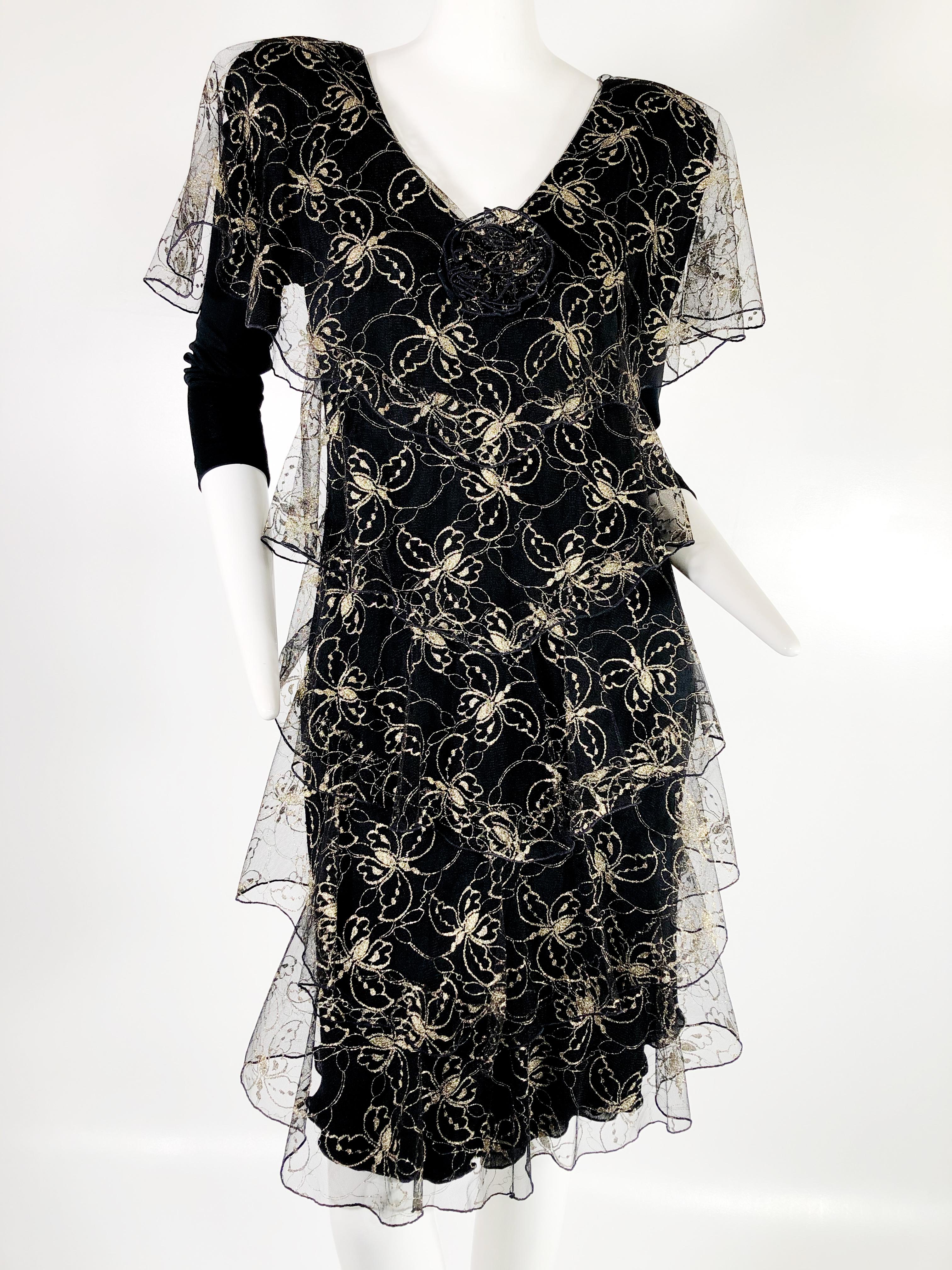 A 1970s Holly Harp matte jersey and net dress embroidered with gold butterflies and tiered.   Fully lined. Back zipper. 