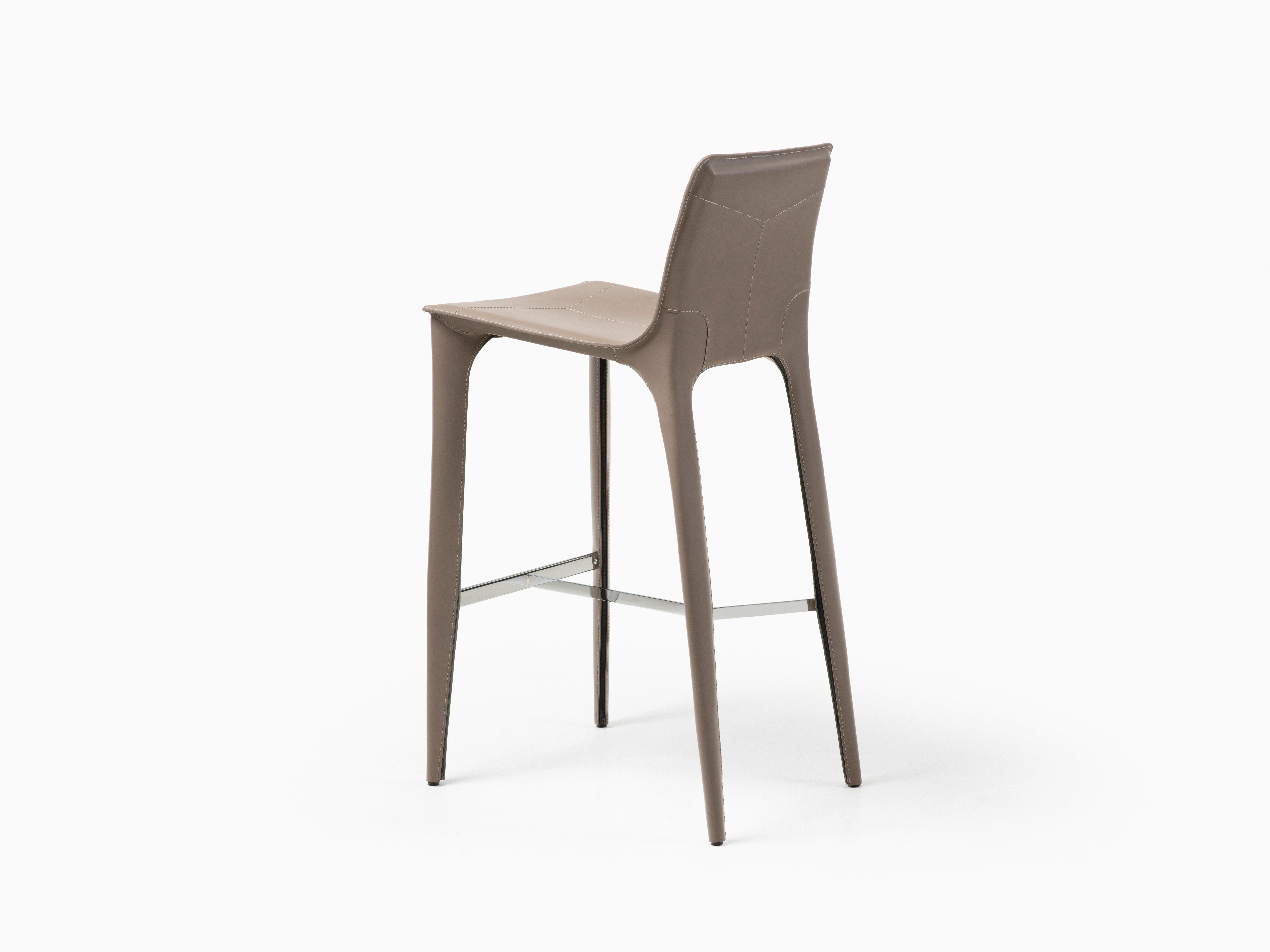 HOLLY HUNT Adriatic bar stool in polished chrome and pine bark leather finish. This simple and elegant bar stool is covered in Italian saddle Leather. From the slightly curved back and slender legs, the lines of this chair flow one into the next for