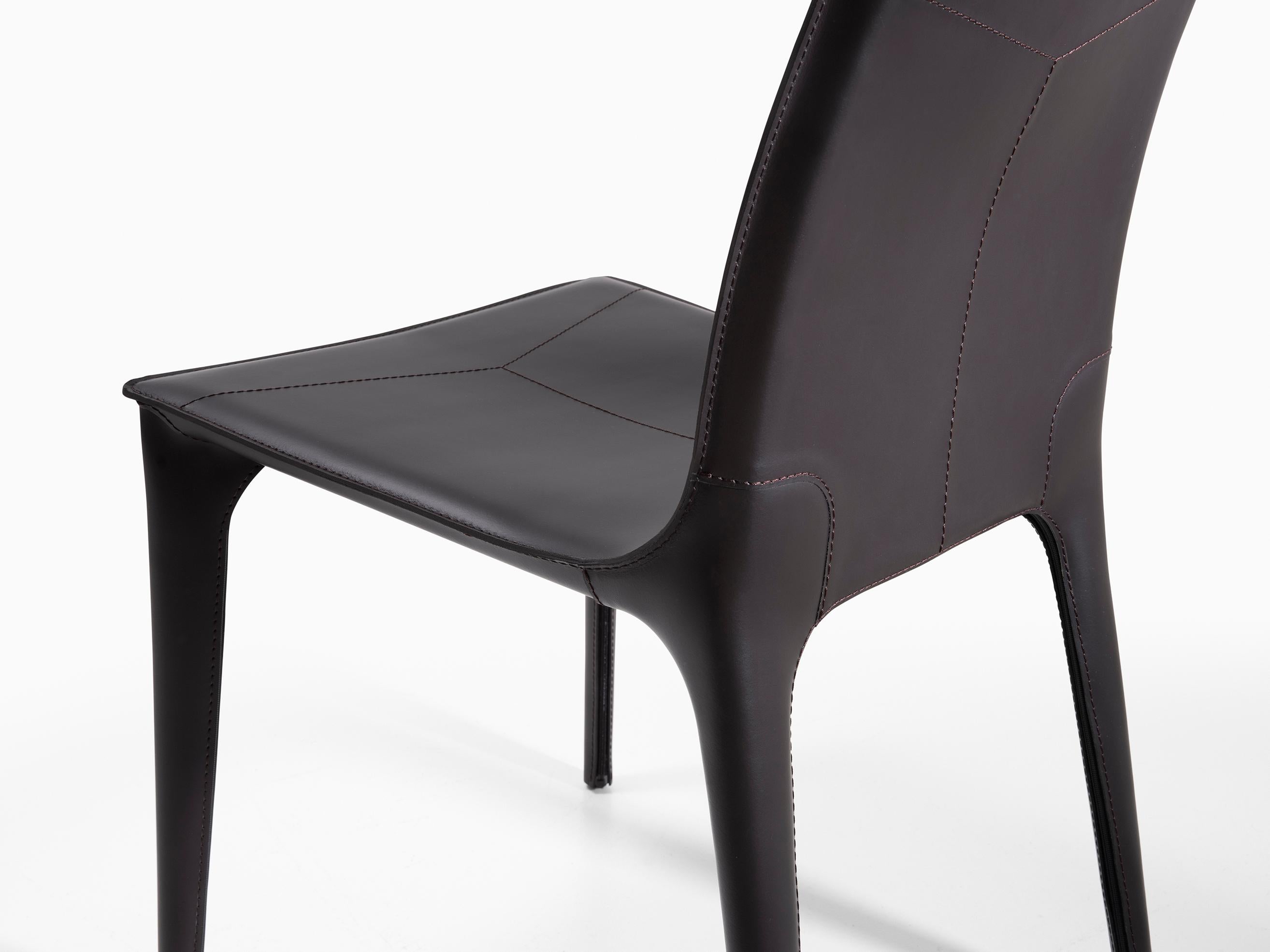HOLLY HUNT Adriatic dining side chair in caffe leather. This simple and elegant dining chair is covered in Italian saddle Leather. From the slightly curved back and slender legs, the lines of this chair flow one into the next for a seamless, modern