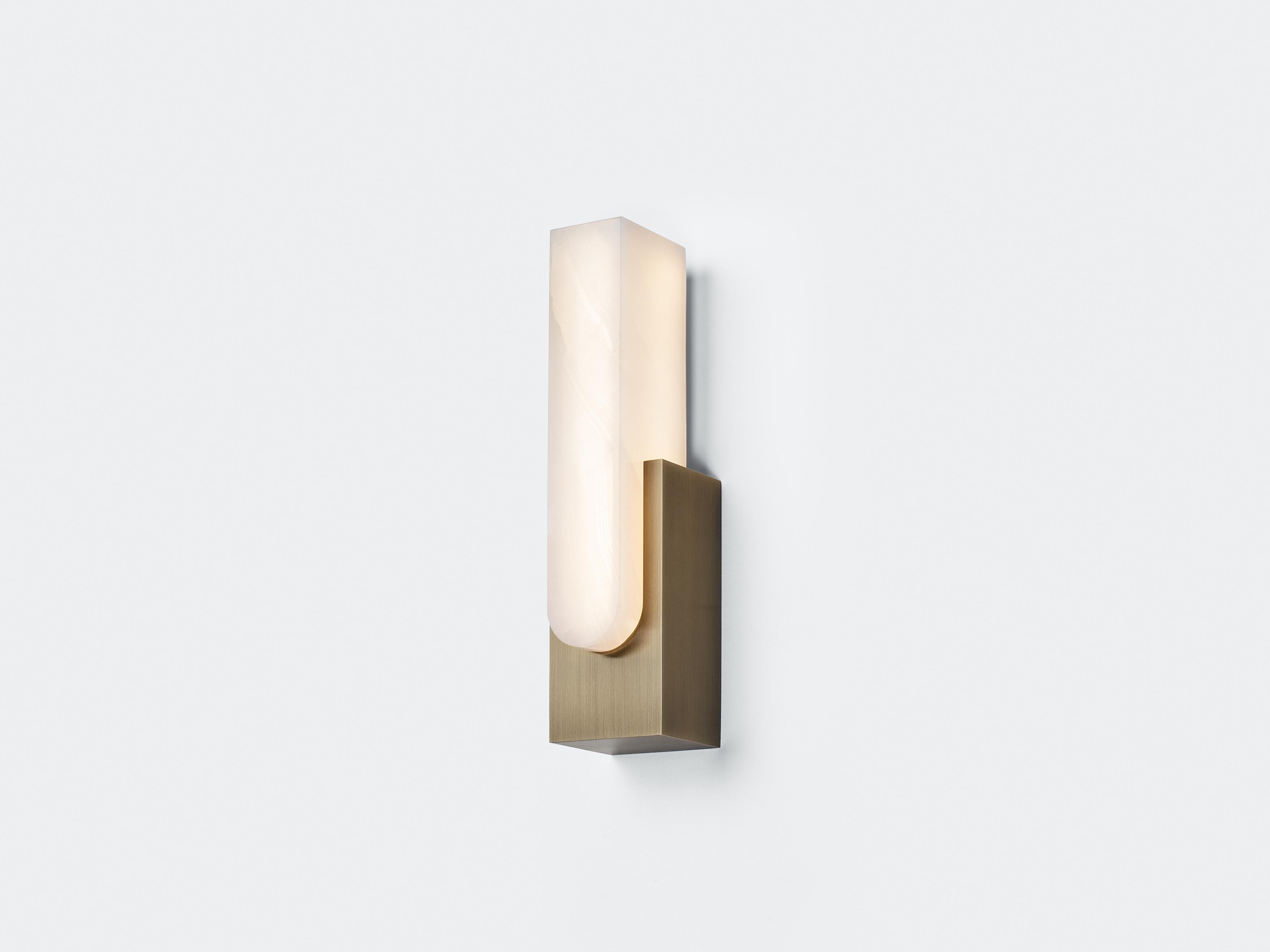 Fusing the purity of brass with the warmth of onyx, the Agatha Sconce revers the natural wonders of both. The inherent translucence of onyx comes alive once turned on, revealing veins and figuring deep in the shade that are unique to each individual