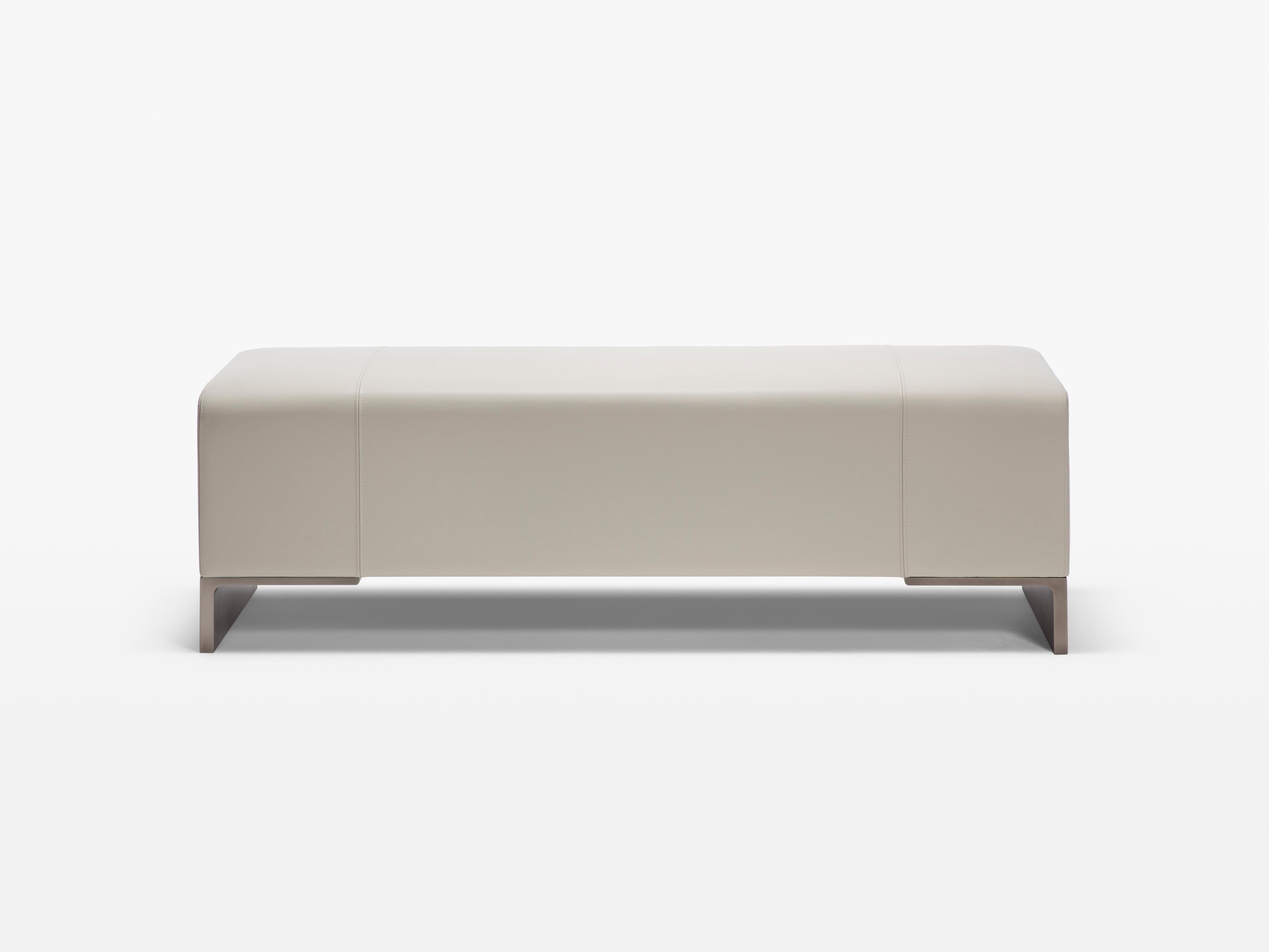HOLLY HUNT Arakan bench in silver smoke and bleached leather. A voluminous bench that brings gravity and softness to any room, ideal at the foot of the bed. Beautiful and modern with a gorgeous brushed metal base. Upholstered in our delicious HOLLY