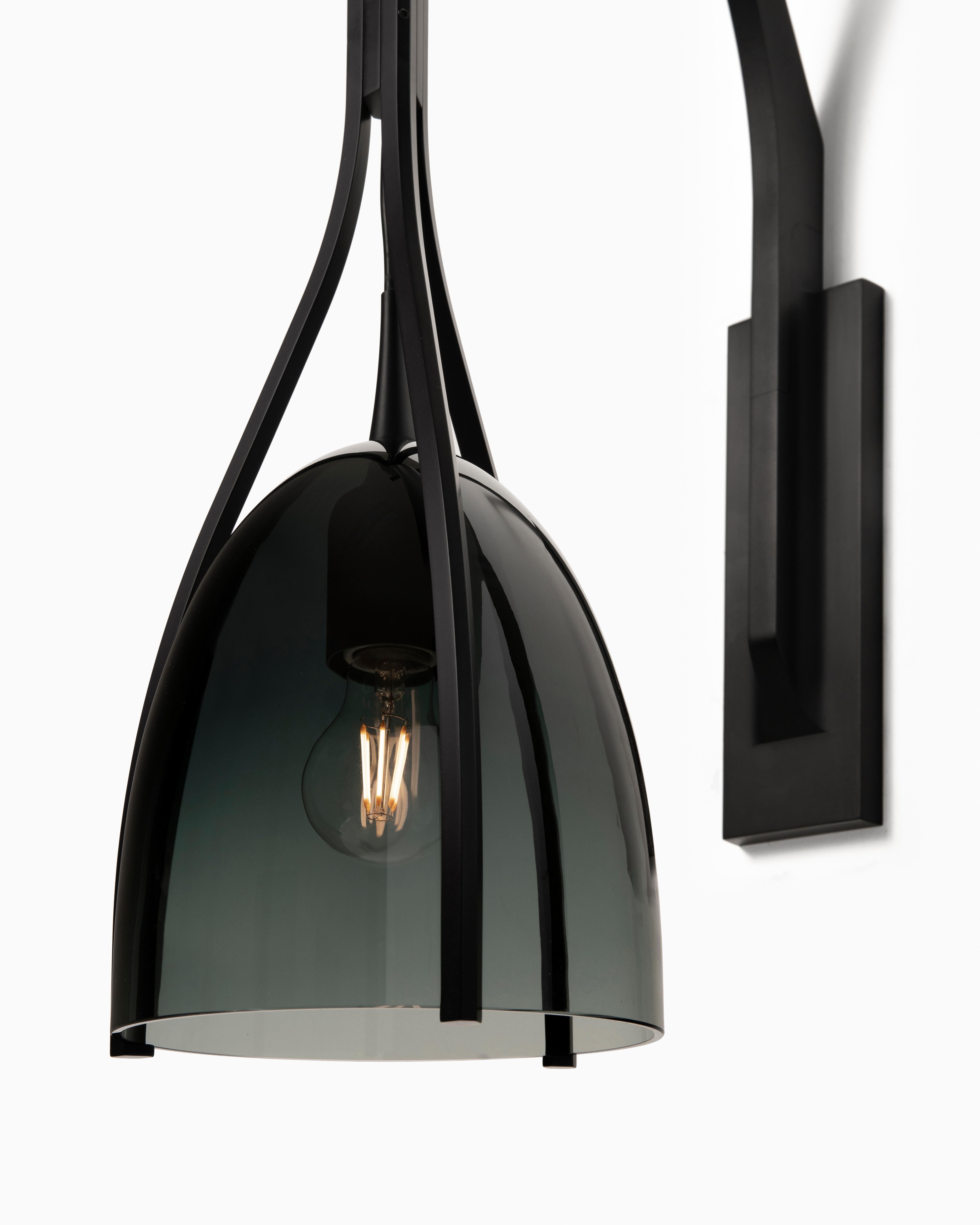 Inspired by the innate sleekness and sophistication heralded by felines, the HOLLY HUNT Black Cat sconce combines hand-blown artisanal glass with the latest precision manufacturing technology. The delicate shade is held suspended by thin, contoured