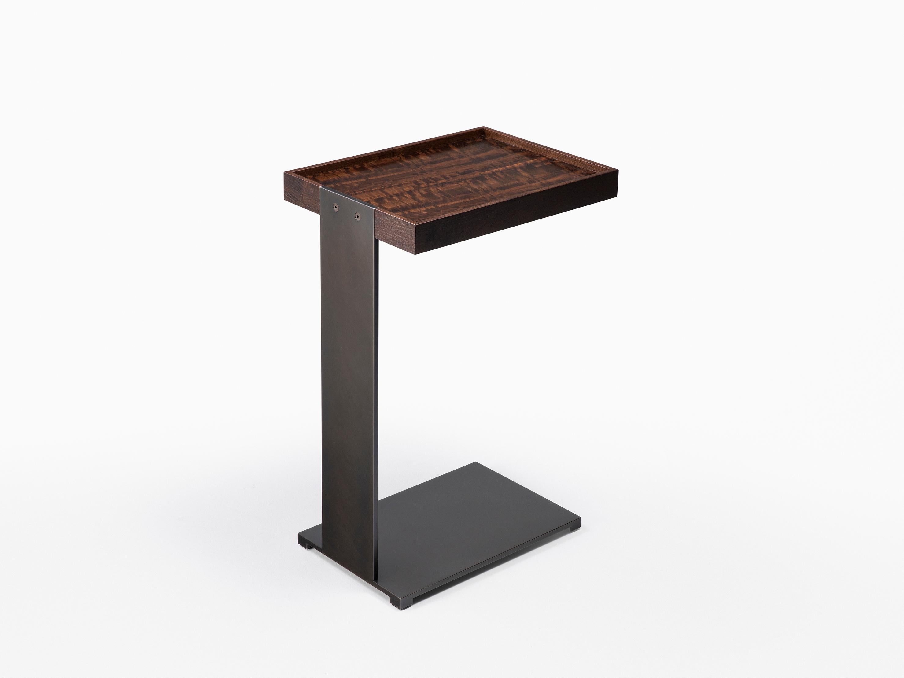 HOLLY HUNT Boulonnais drink table in wood top and metal frame. An angular side table distilled from simple geometry with a cantilevered tray top. Useful when placed hugging a sofa as the perfect spot for a coffee or cocktail. A practical and mobile