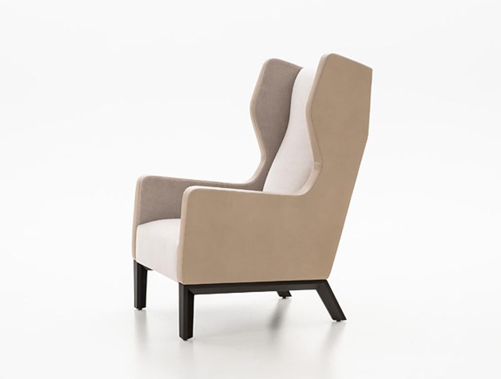 Holly Hunt Darder wingback chair with walnut legs and beige upholstery

Additional Information:
Materials: Walnut, upholstery
Frame finish: Walnut black magic
Outside back and arms: Stingray/driftwood
Inside back, arms and cushion: Silk &