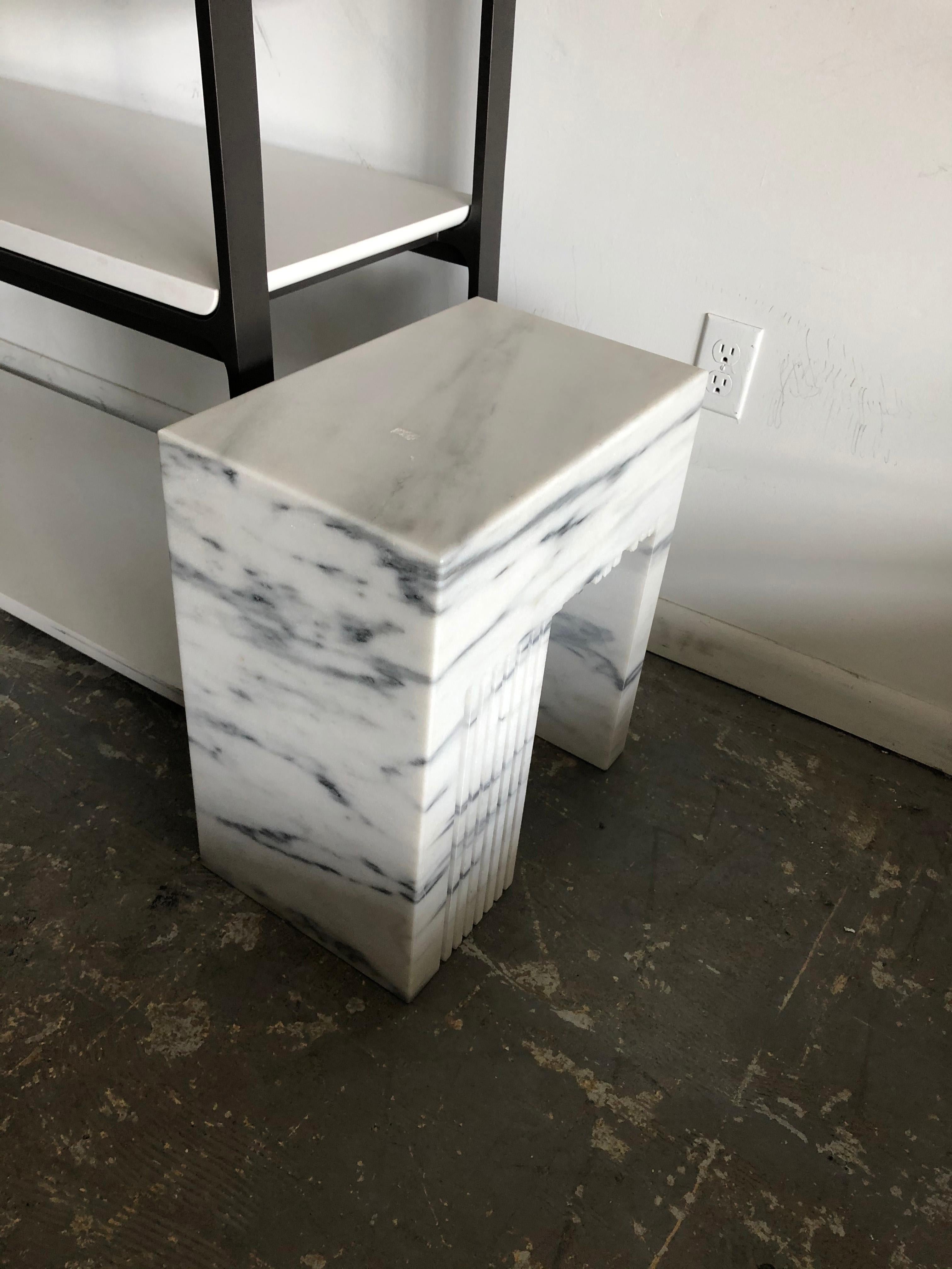 Holly Hunt Fin side table (V1) with 9 legs by Eric Slayton 

Known for his concrete benches at Holly Hunt, Eric Slayton has a rustic and Minimalist aesthetic, highlighting the imperfections in his materials and forms. White Dandy Marble, unique,