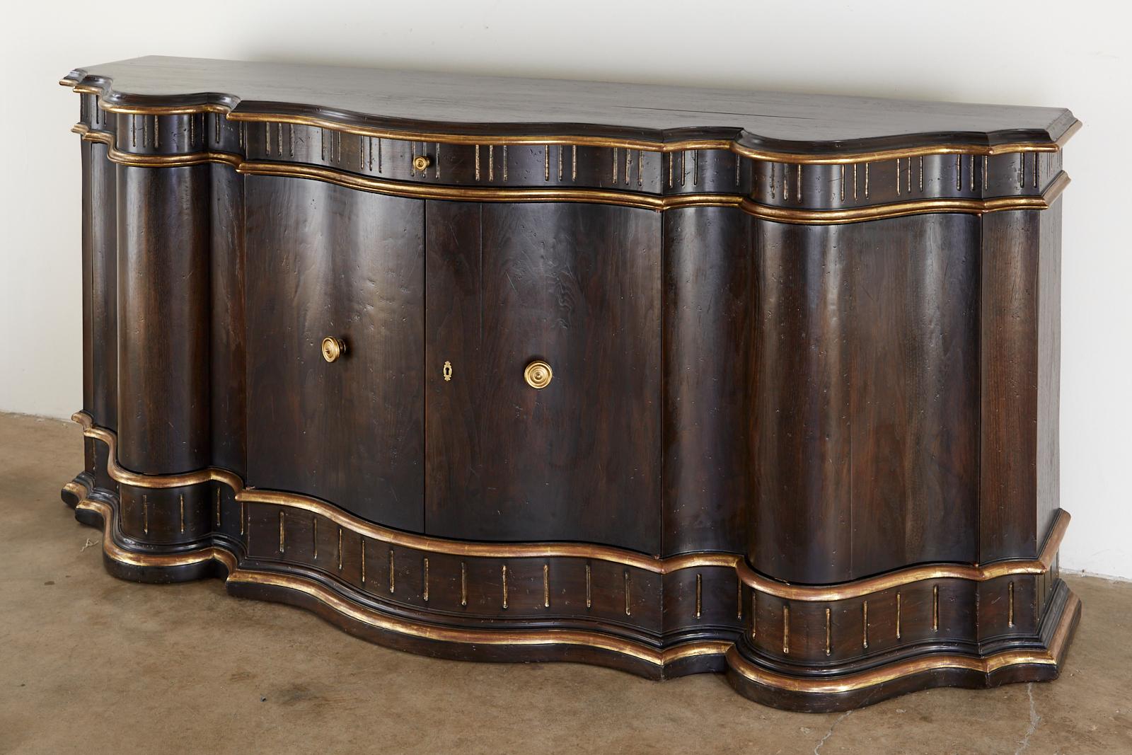 Dramatic ebonized walnut sideboard or buffet by Holly Hunt for Therien studio workshop. Features a large serpentine case in a dark patina with a parcel gilt finish. Bespoke piece made for an estate in Atherton, CA. Features two large doors in front