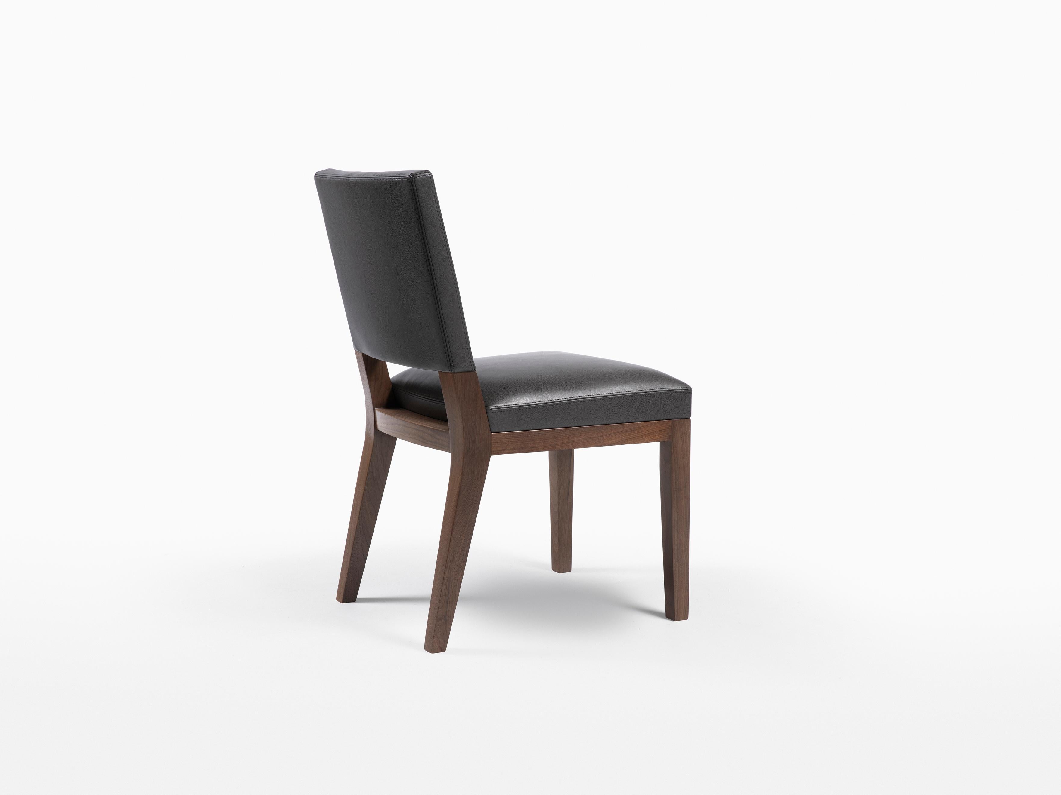 HOLLY HUNT Luna dining chair in walnut dusk finish with upholstered seat. At the top of its class in finish and construction, this chair is the quintessential side chair design. Easily suited for any style dining table, this chair is made up of