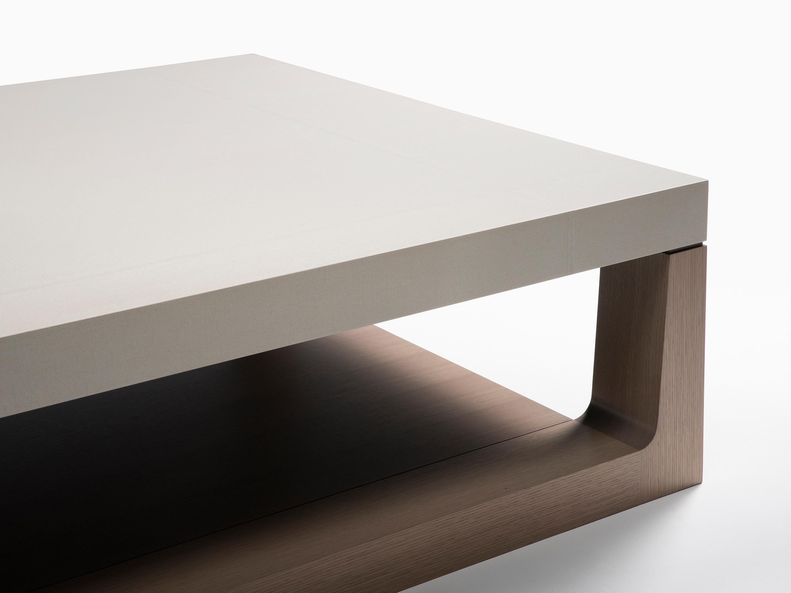 HOLLY HUNT Mojave cocktail table with bottom shelf in oak and linen top. A simple modern cocktail table that combines the applied linen finish with robust wood craftsmanship. Gentle transition details connect an overall calm, large scaled, grounding