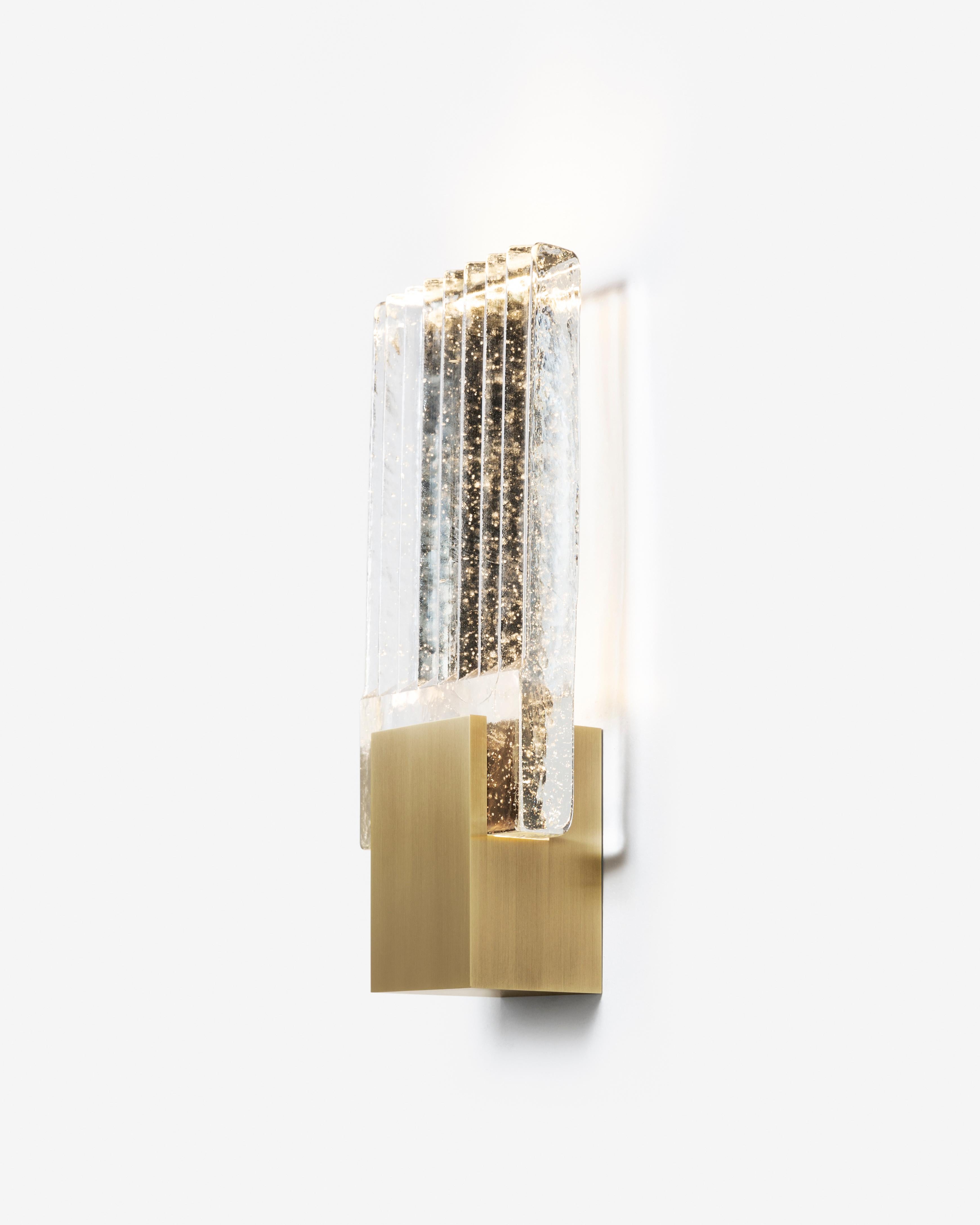 Alluding to the rich traditions of 1940s French decorative arts, the cast glass of the Pleated Glass Sconce features vertical striations that reflect light with an appealing effect.

Additional Information:
Structure: Bronze and Cast Glass
Structure