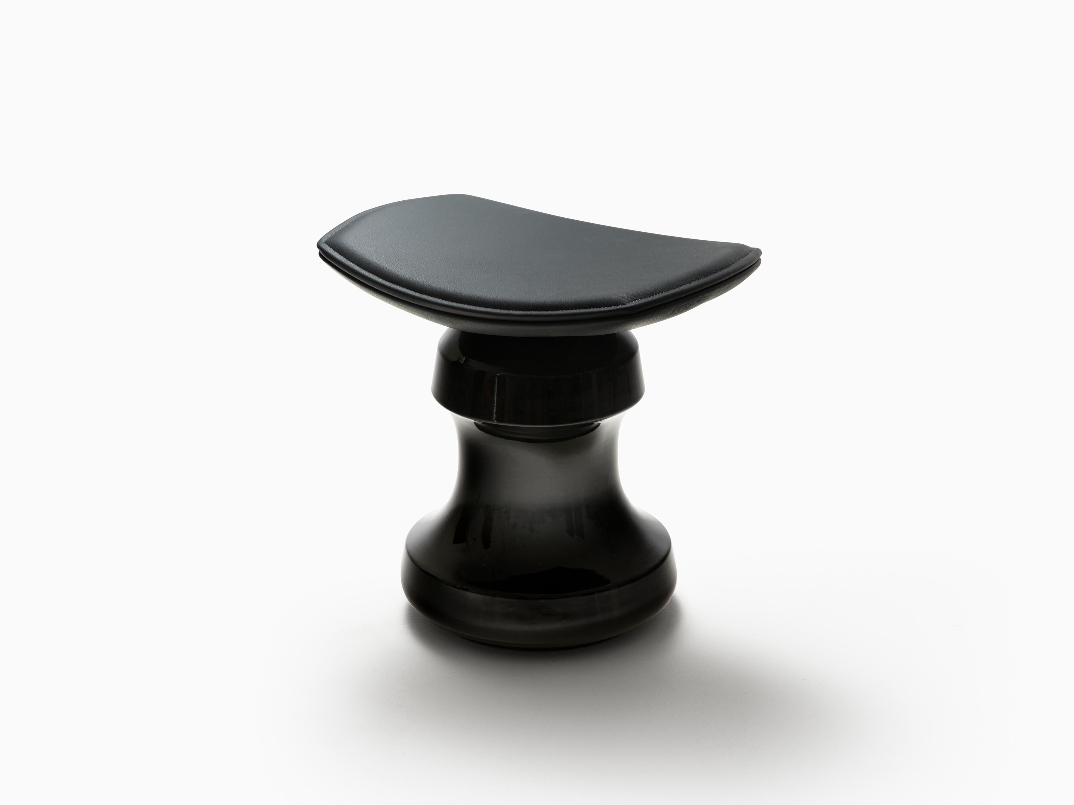 Designed by Christophe Delcourt for HOLLY HUNT. Evoking the outline of a chess piece or a pommel horse, Roi stool is a statuesque piece of ceramic topped with a curved leather seat. A light, sensual and well-built piece which feels comfortable