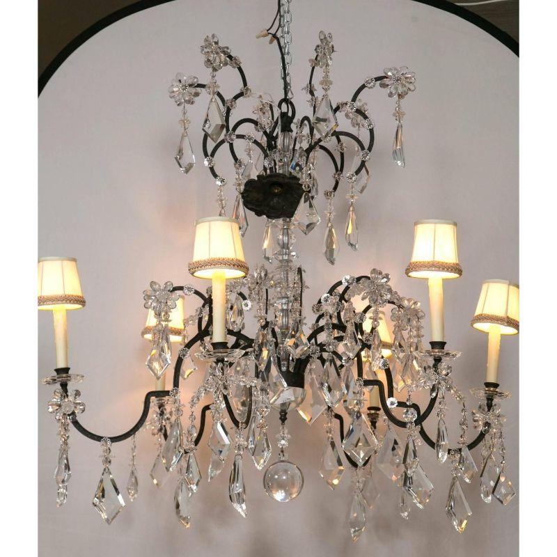 A Holly Hunt wrought iron and crystal scroll form chandelier. From a spectacular home on the North Shore of Long Island comes this fine Holly Hunt wrought iron and crystal chandelier. This iconic designers style and flair are shown at every angle of