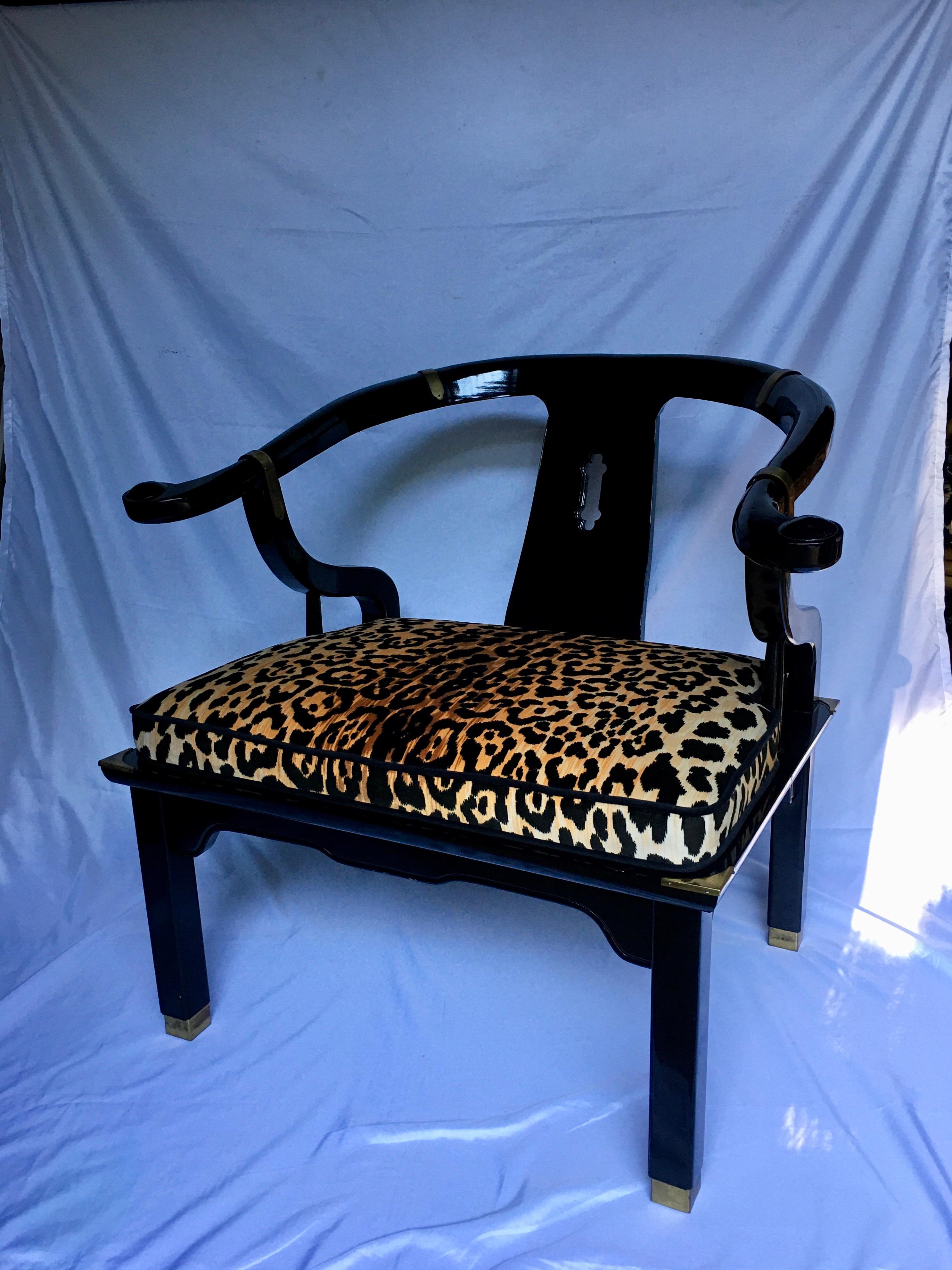 Hollywood Regency style lounge accent chair by Century Furniture. This James Mont style armchair features a gloss black lacquer wood frame with brass hardware accents. Cushion is newly upholstered in a cotton-velvet animal print fabric and piped in