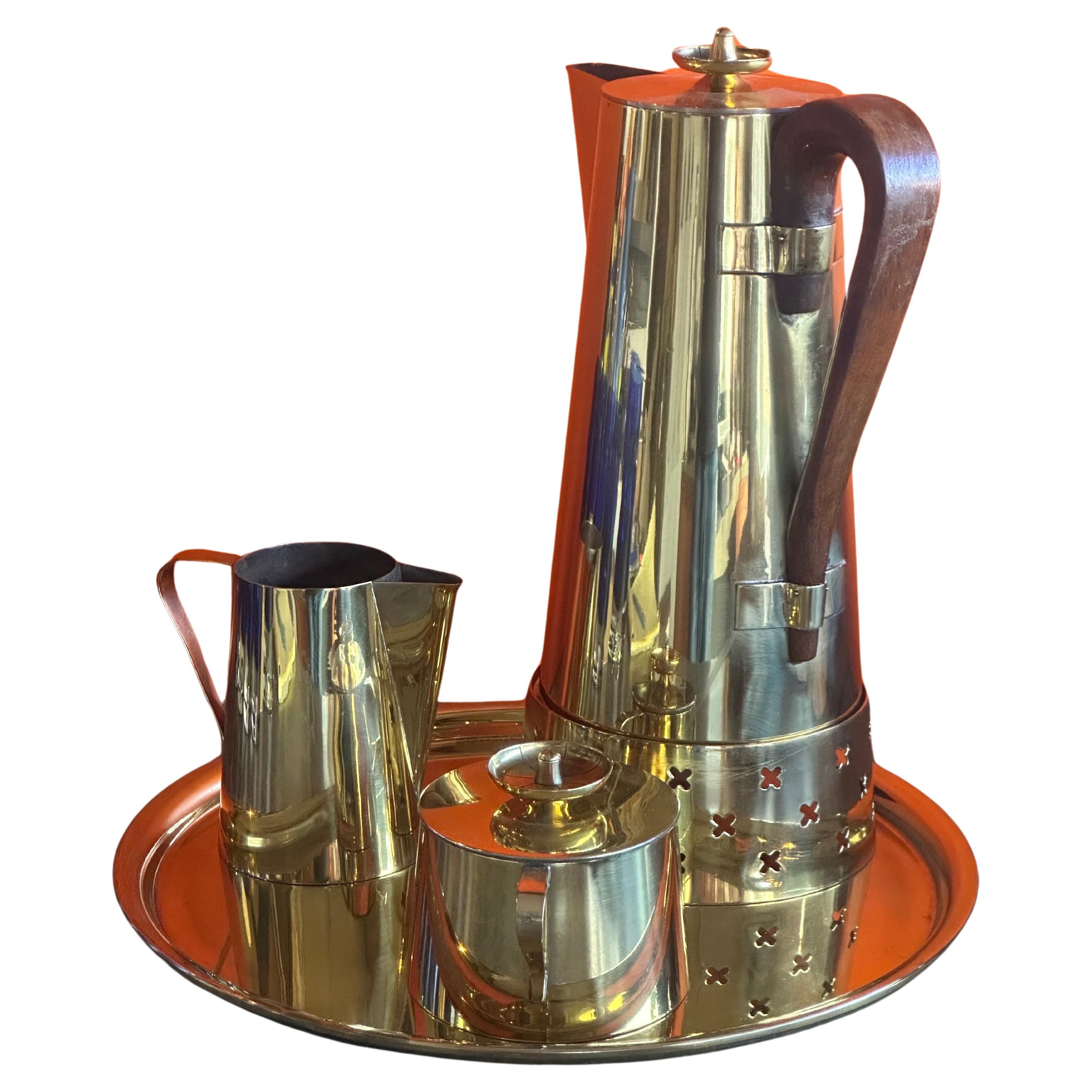Stylish Hollyood Regency brass coffee set by Tommi Parzinger for Dorlyn Silver, circa 1970's. The set includes a coffee pot (including Sterno riser), creamer, lidded sugar bowl and serving tray.  The coffee pot is 6