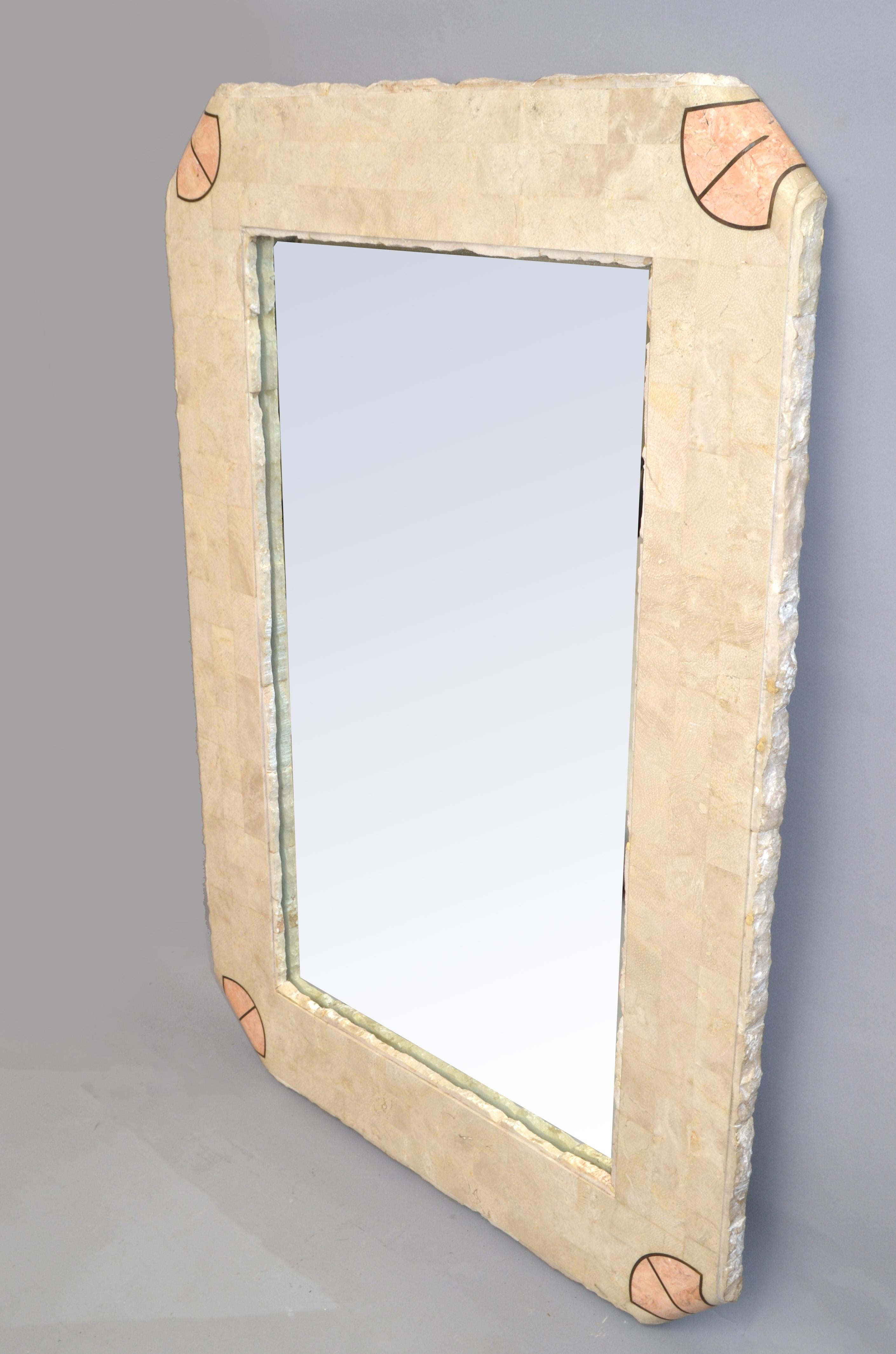 Handcrafted rectangle Stone over Wood tessellated mirror with beige and apricot color stone crossbands with Brass inlays.
Asian Modern made in the Philippines for Maitland Smith in the 1980.
Mid-Century Modern Design for any interior Style.
Mirror