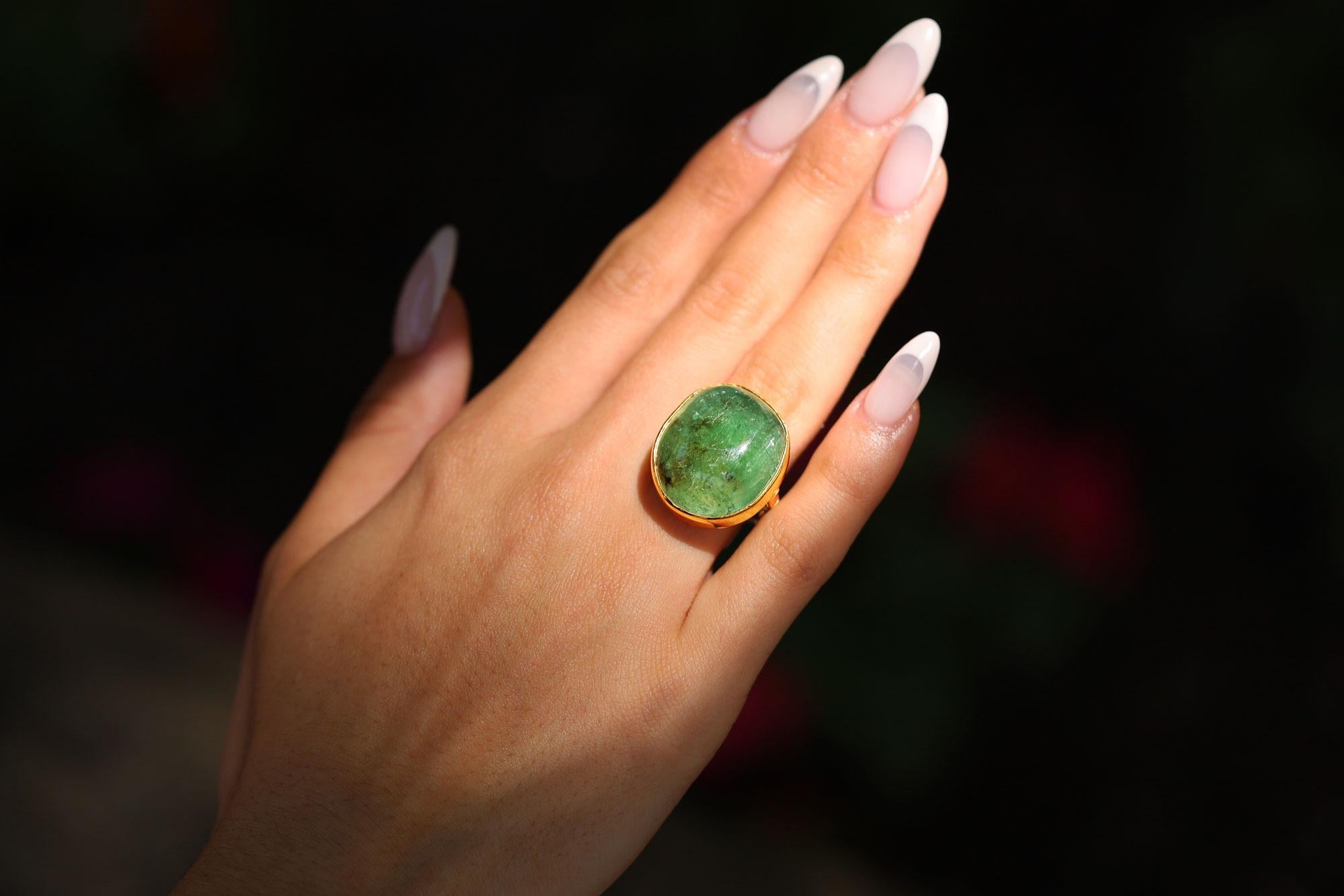 A gift from Hollywood legend Robert Mitchum to his wife Dorothy, this circa 1960s cocktail ring is a treasure for the ages. Centering upon a glowing green beryl gemstone of a significant 33 carats in weight and surrounded with an 18k yellow gold