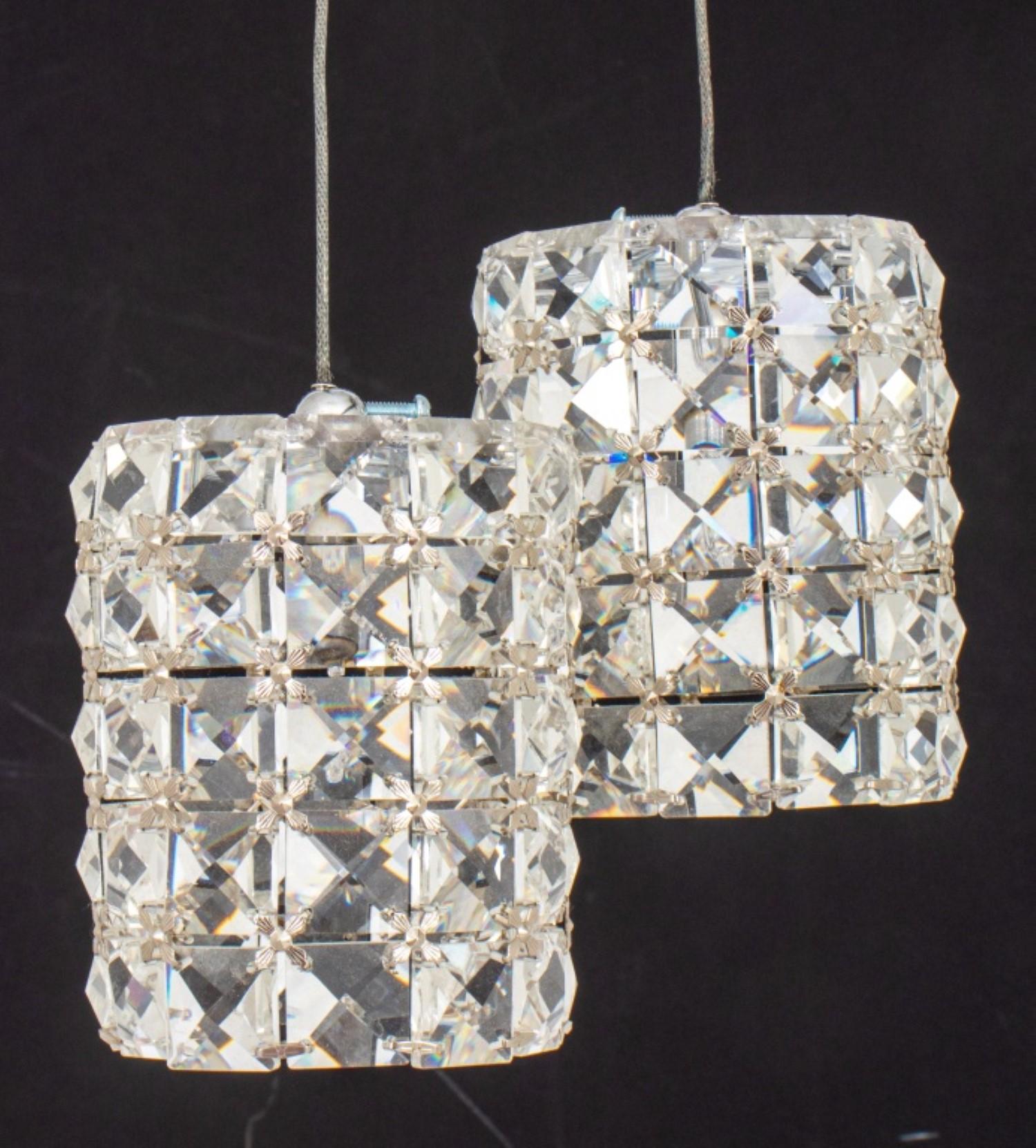 Pair of Hollywood Glam crystal pendant drop  lighting fixtures, with spherical chromed  canopies with pendant lights in  Swarovski-style crystal drum shades. 

Dealer: S138XX

