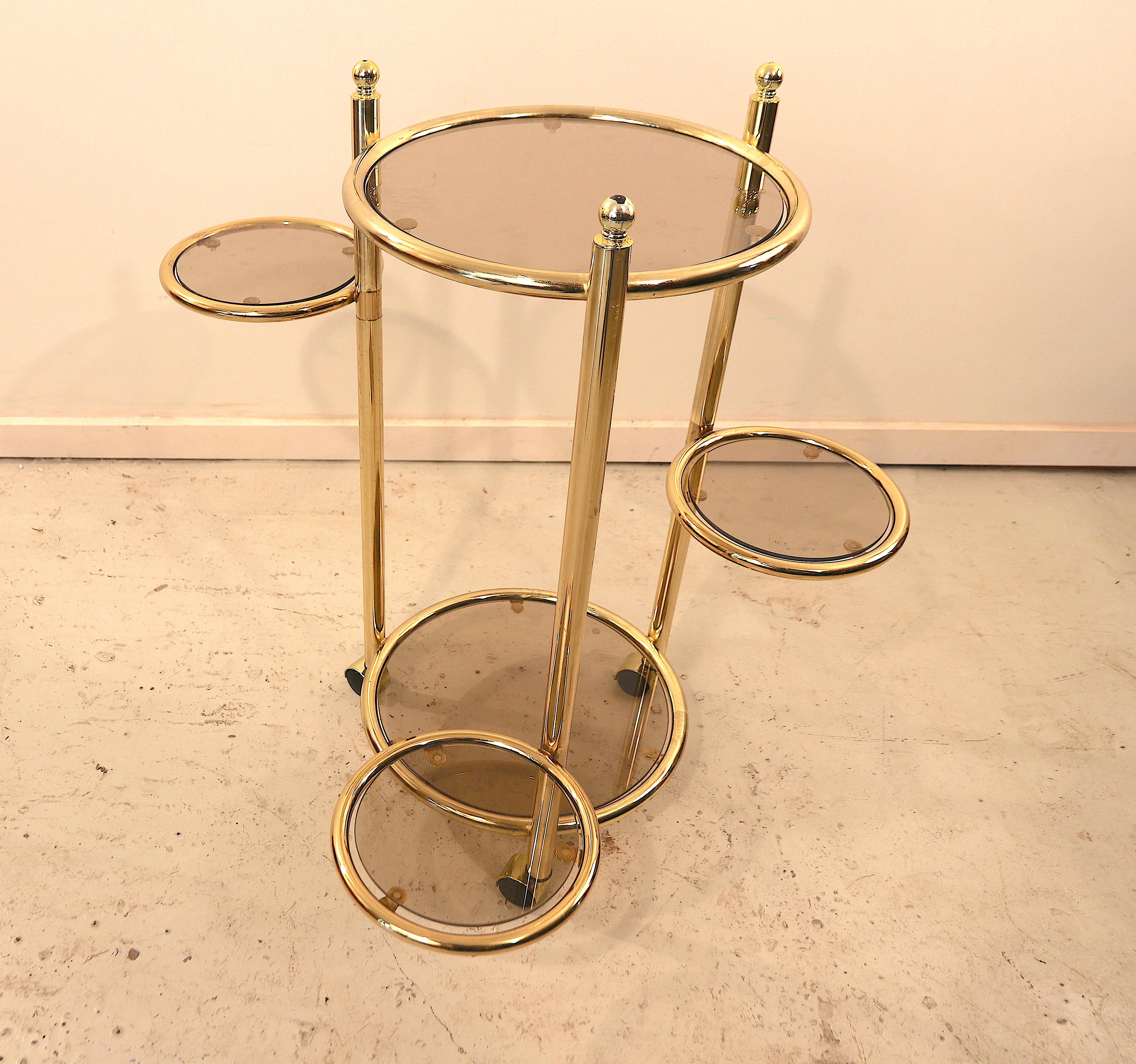 Cute and beautiful side table on 3 casters with 5 glass tops of which 3 can turn a 360 degrees. Ideal to place aside a sofa or a higher lounge chair. This piece is completely in the style of Maison Jansen and Maison Charles, French manufactured. All