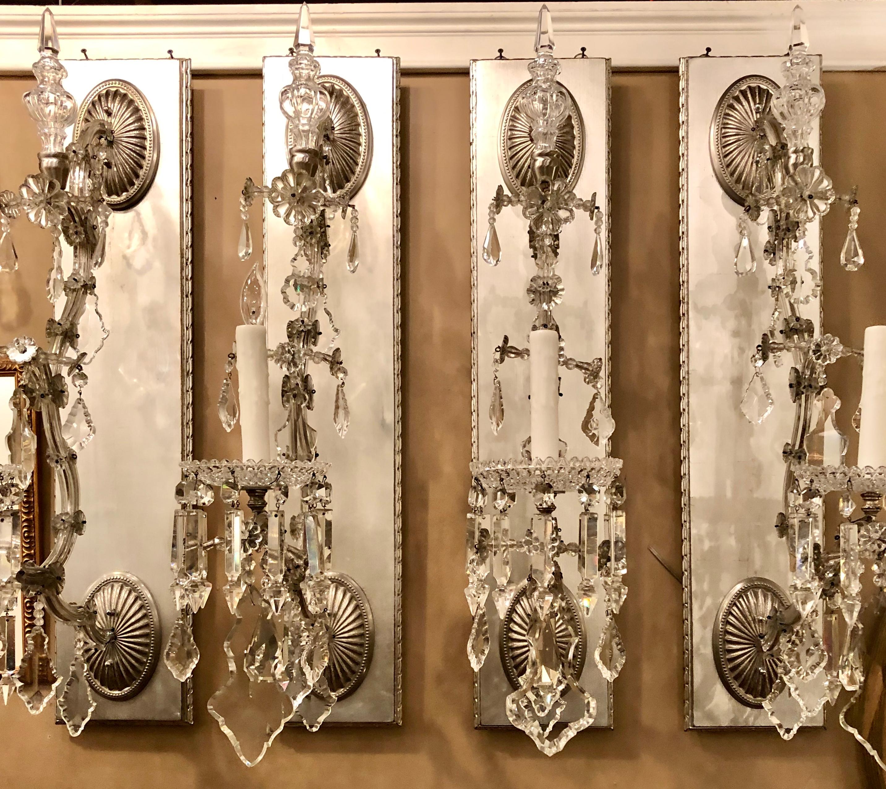 Hollywood Regency Silver gilt wall scones with crystal set of four. A finely gilt set of four palatial silver one light wall sconce with crystal prisms and bobeche. A stunning set of four. Can purchase two if only one pair are needed.