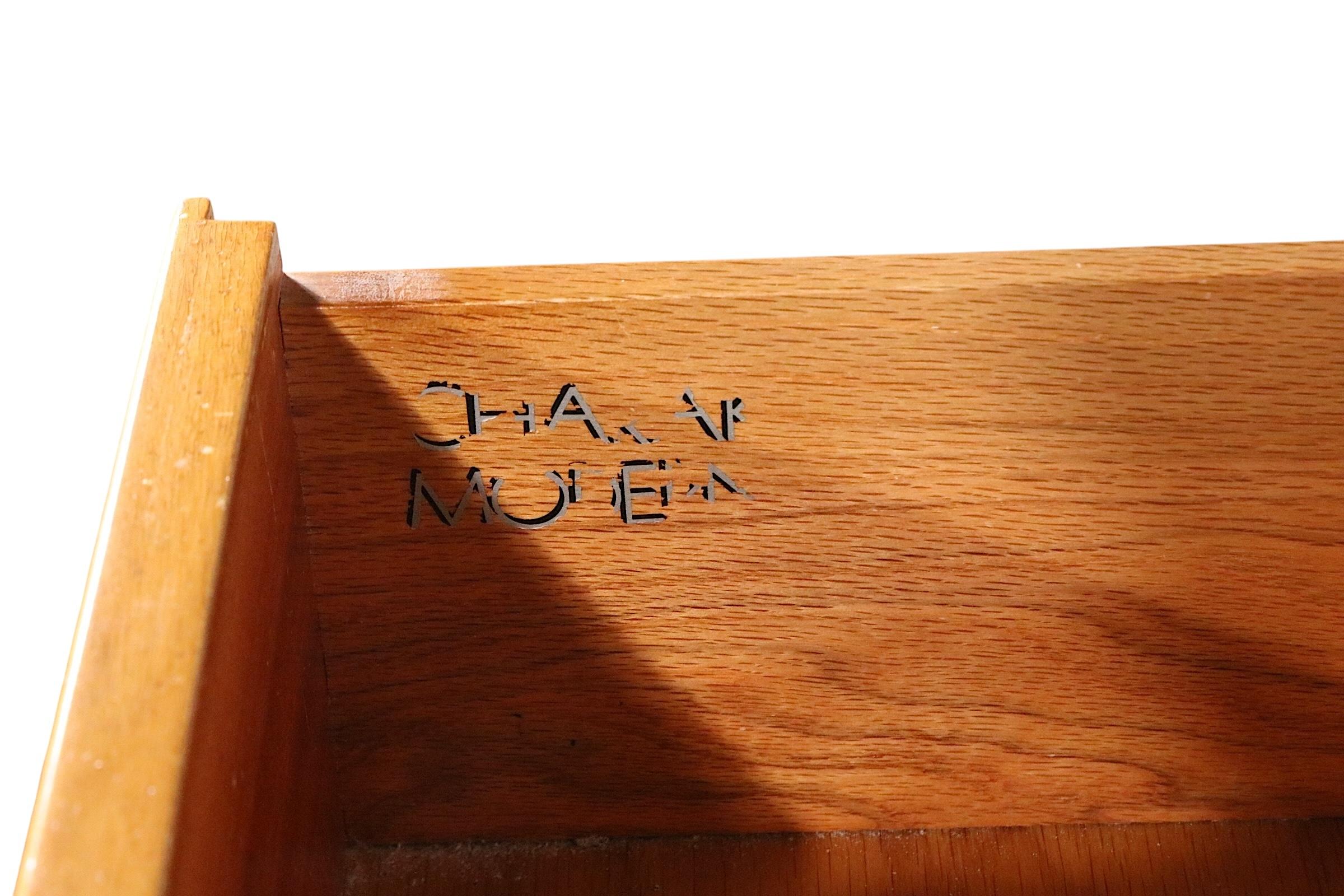 Exceptional, rare, voguish, and chic twelve drawer dresser designed by Tommi Parzinger for Charak, circa 1940's. The cabinet features a mahogany case in original blonde finish, with heavy cast brass hardware. The design exhibits the elegance and