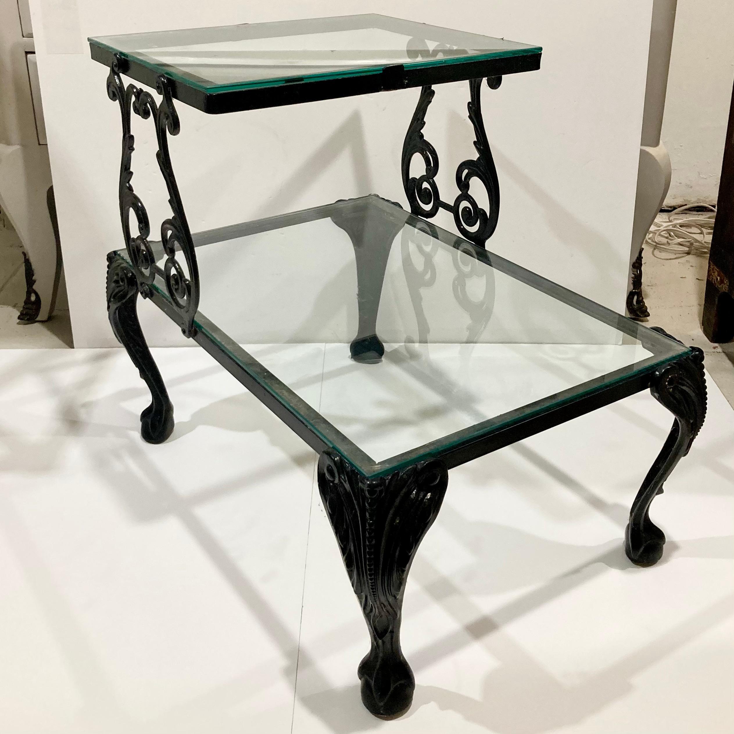 Gorgeous Hollywood Regency 2-tier patio table. Nice black finish and new glass on both levels. Add this to your collection or keep shopping with us as we love to feature this collection of Hollywood Regency patio furnishings.