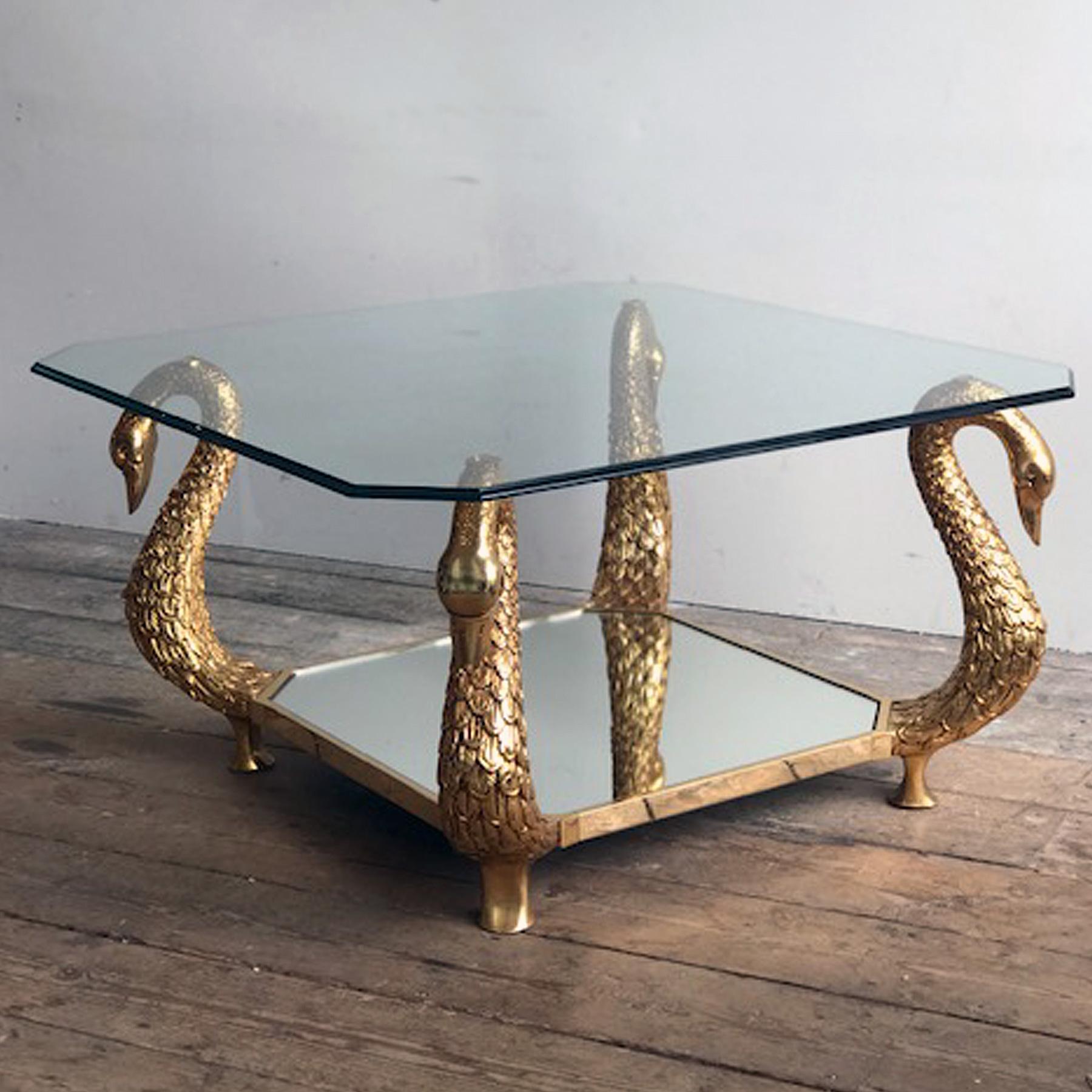 A very decorative 20th Century Coffee table / side table, x4 elaborite Swan necks holding a beveled glass plate and with a mirrored bottom.

Definiely a table which will fit an eclectic style with some Hollywood Regency Glam.