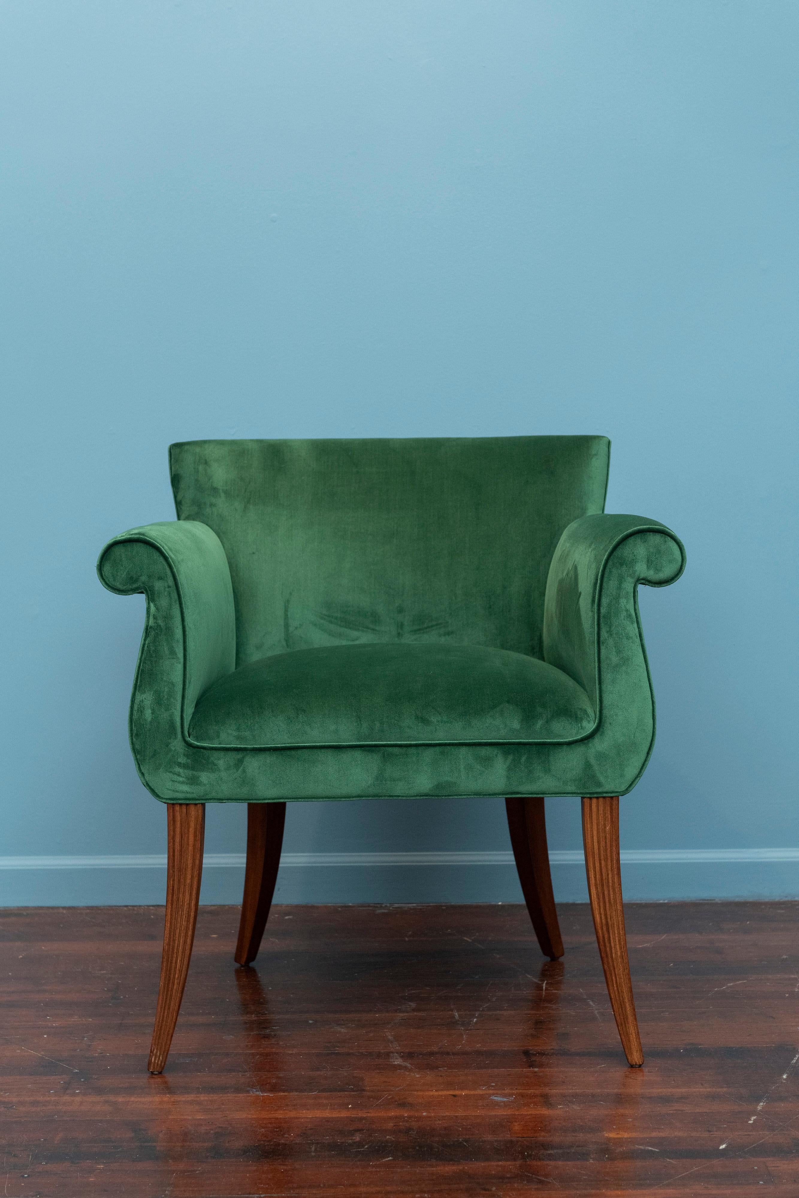 Hollywood Regency style jade green velvet upholstered armchair. Elegant armchair perfect for occasional seating or as a desk chair. Featuring splayed reeded legs with flared arms and a tight seat. Newly restored including a strengthened frame,