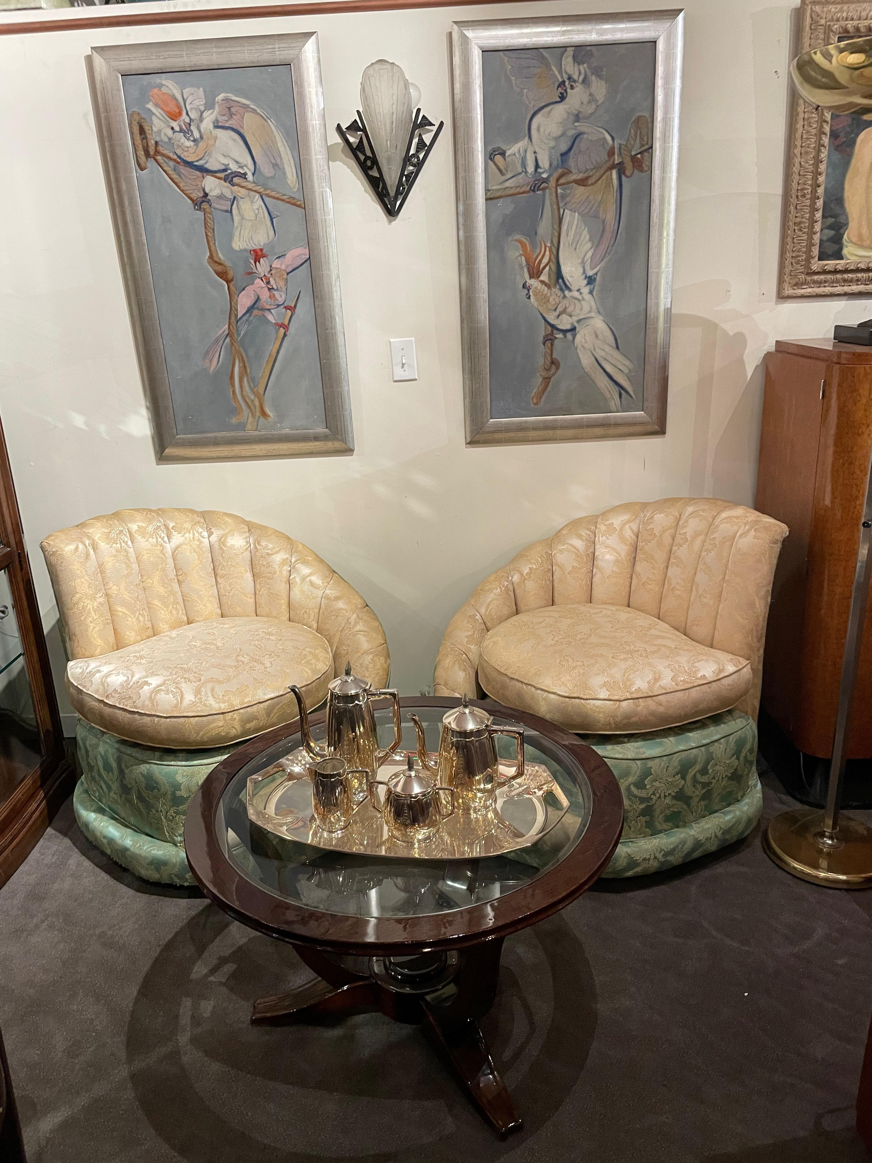 A pair of channel fan-backed chairs upholstered in brocade in a style that is a combination of Art Deco and Hollywood Regency. The cream and aqua brocade are the same pattern done in two colorways with a sweep of the cream that cascades from the