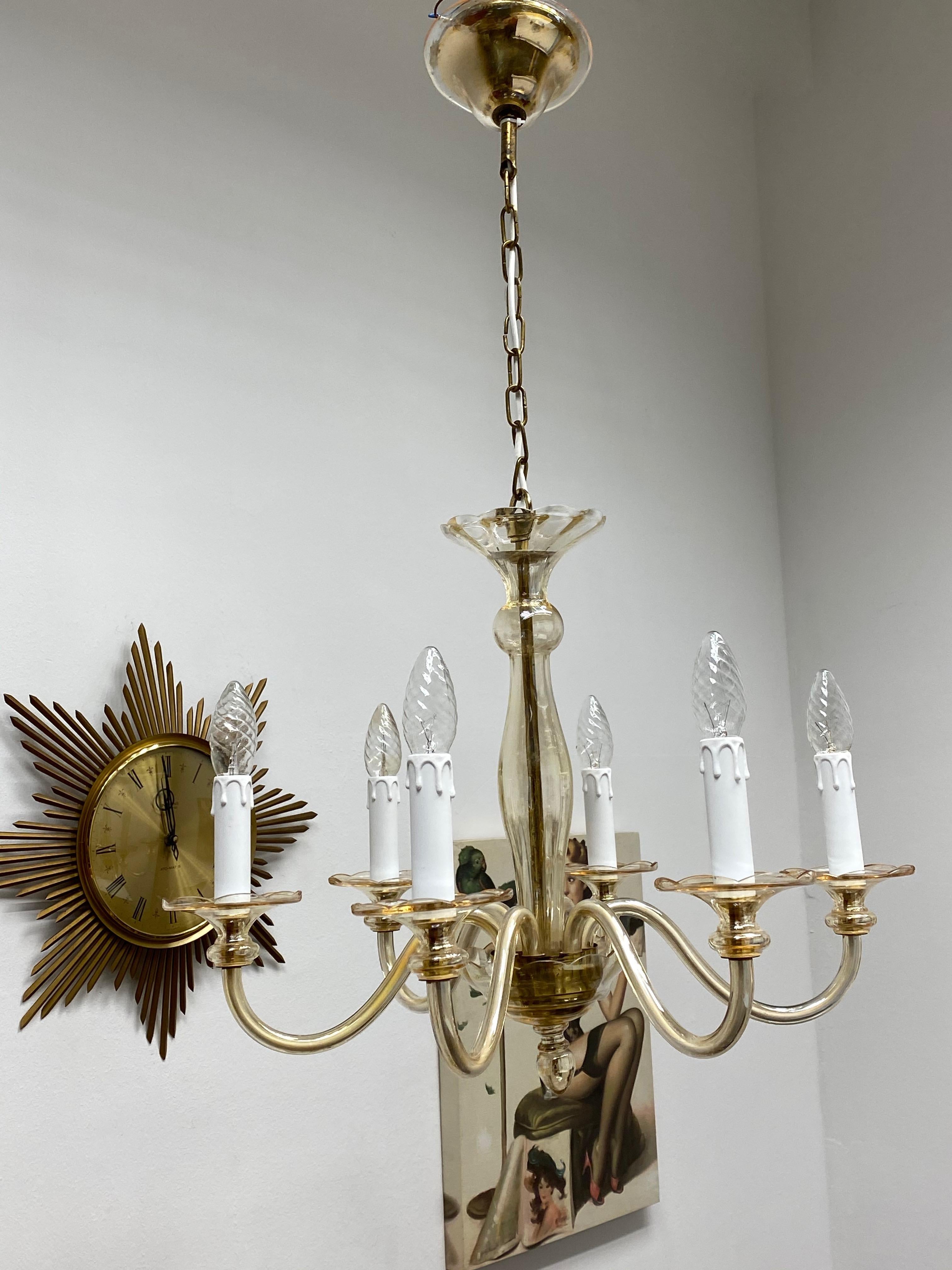 Stunning and beautiful chandelier. Made in Murano, Italy, circa 1960s. The Chandelier requires eight European E14 candelabra bulbs, each up to 40 watts. It is a real treasure and gives any room a beautiful ambience. Light bulbs are not included.