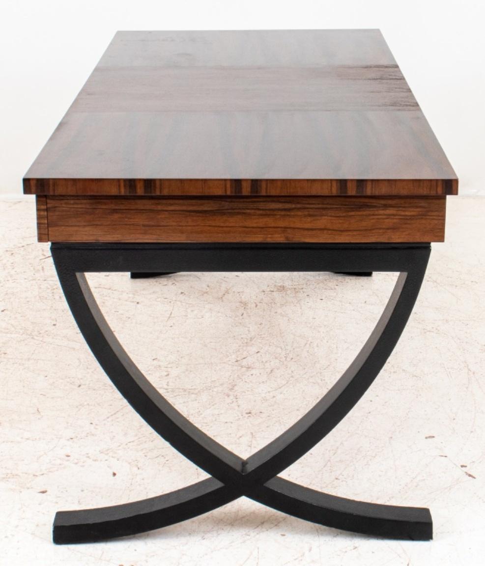 Hollywood Regency Art Deco style desk, the rectangular figured walnut top with three drawers to one side, above shaped ebonized x-form supports. 

Dimensions: 28.5
