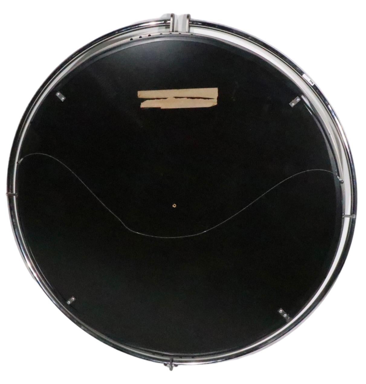 Spectacular Hollywood Regency, Art Deco Revival mirror by Design Institute America, circa 1992. The mirror is constructed of a center panel, of bevelled glass ( Dia. 36 in. ) surrounded by a tubular chrome ring  ( Dia. 40.5 in. ). Exceptional