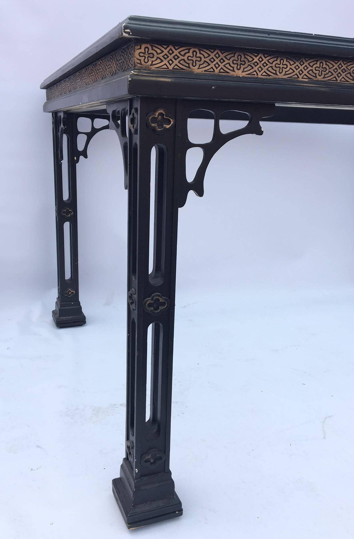 Offered is this black Chinoiserie dining table with inset glass top. Features fretwork legs and gold accents. 
Good vintage condition with age appropriate wear with abrasions to the finish.
As always, all reasonable offers will be considered.