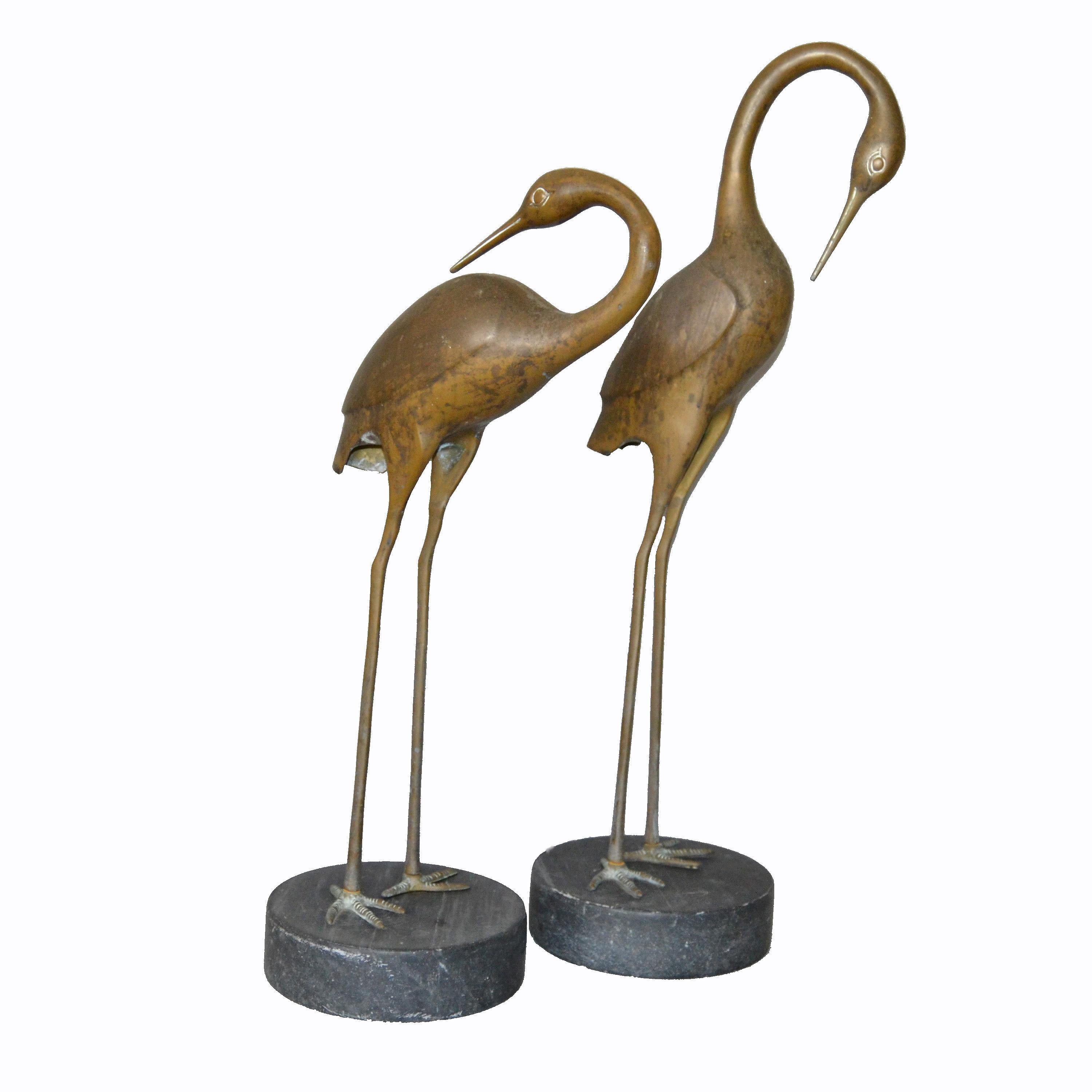 A pair of vintage bronze Asian inspired crane sculptures on black-gray marble bases.
No markings.
Can be used for indoors and outdoors.