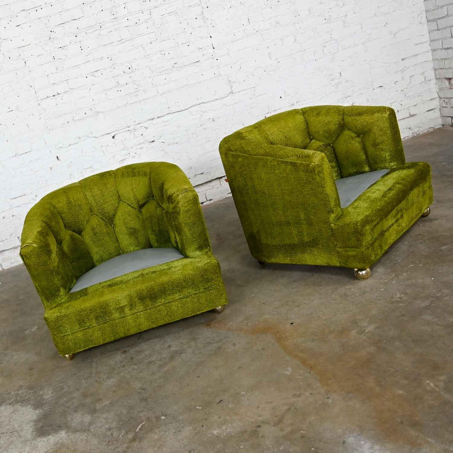 Gorgeous Hollywood Regency avocado green crushed chenille button tufted barrel chairs with new brass ball casters on front legs and small tapered legs on back and new dust covers. Beautiful condition, keeping in mind that this is vintage and not new