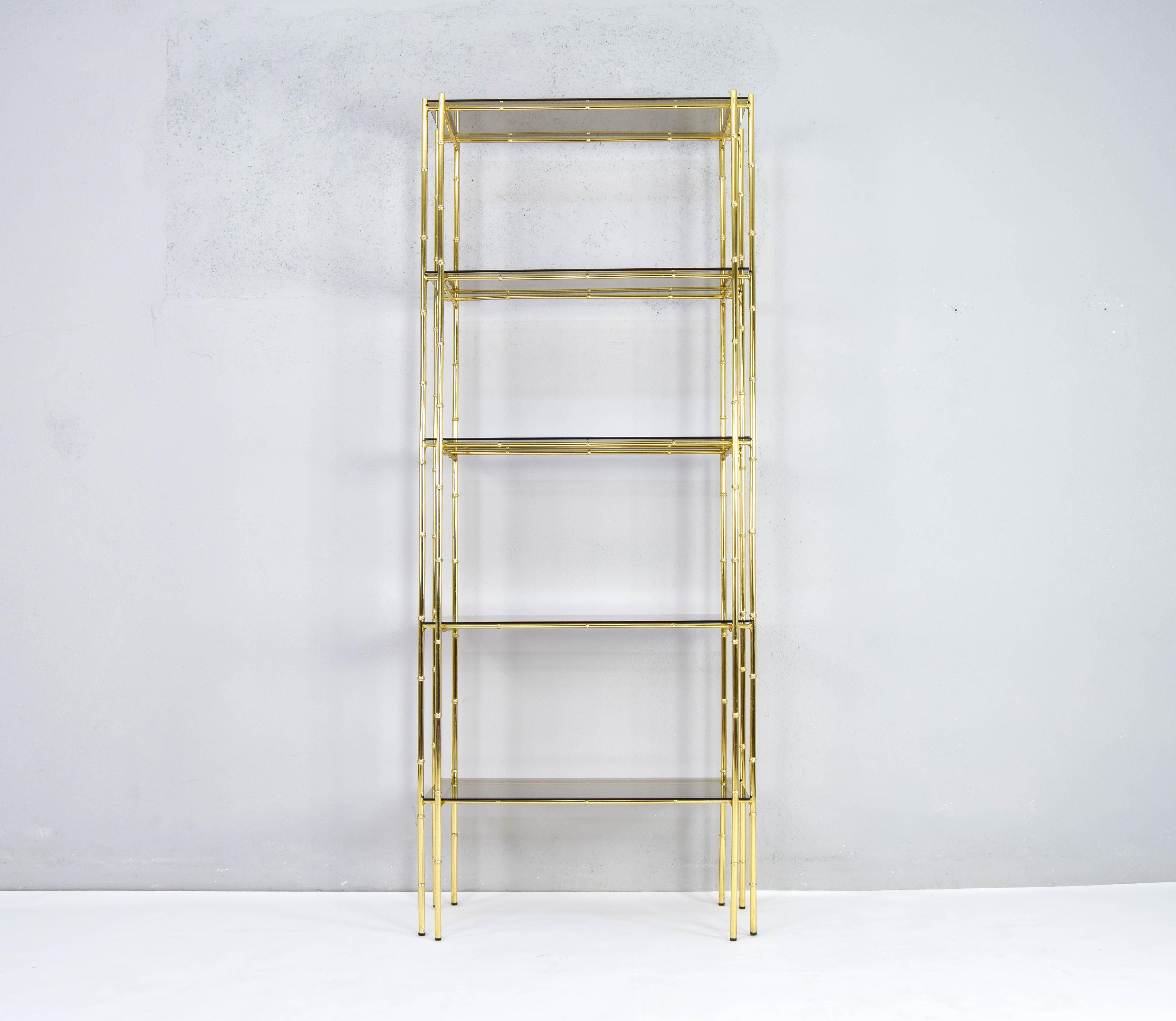 Great five-shelf bookcases manufactured by the now defunct Spanish company Bosquesot, Manises, Valencia in the 70s.
Golden steel structure in the form of delicate bamboo rods and smoked glass shelves.
Hollywood Regency in style, this piece is