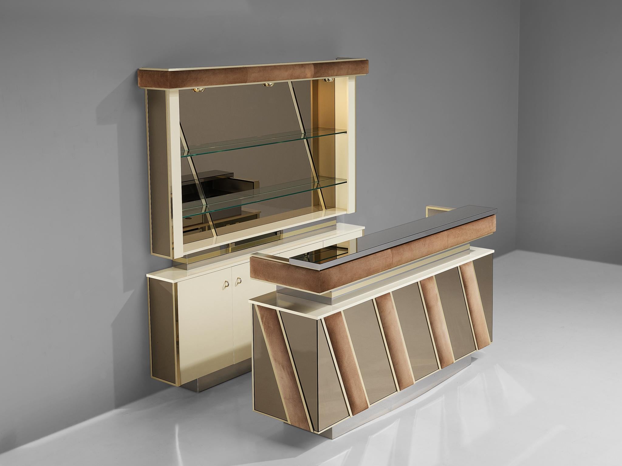 Cocktail bar, stainless steel, suede, brass, glass, mirrored glass, wood, metal, Italy, 1970s

Hollywood Regency cocktail bar in the style of Willy Rizzo. The set includes a counter element and illuminated cabinet, with chrome and suede details. The