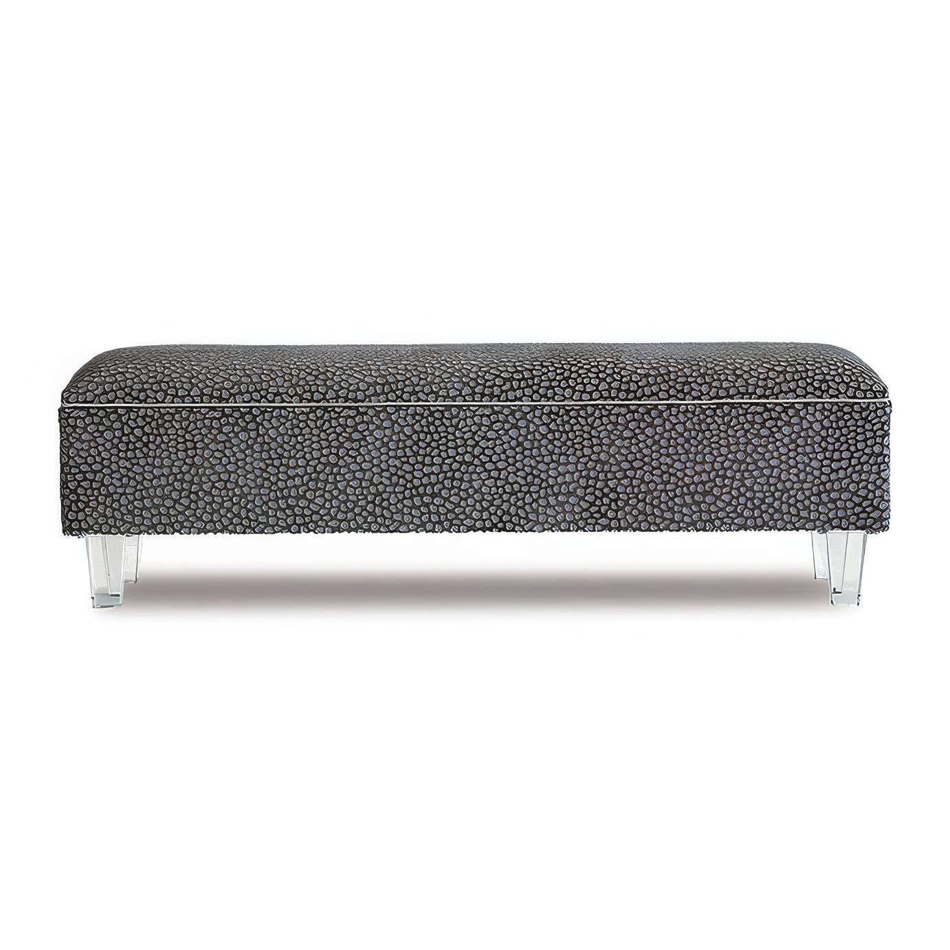 Handcrafted in the USA, this vanity-height bench is upholstered in a striking ocelot woven patterned fabric, offering a bold yet elegant statement. A small welt trim around the edges enhances its tailored appeal, while the high-density foam cushion