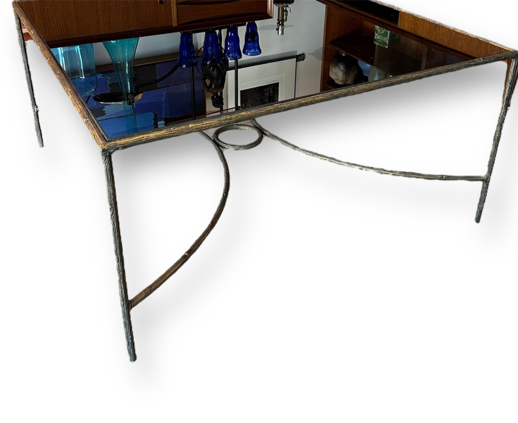 Very cool, sleek coffee table the twig that’s in printed into the base of this table is very beautiful. It has a dark brown-ish black patina in the brass metal. Please read the notes about the condition of the glass. The price is really focused on