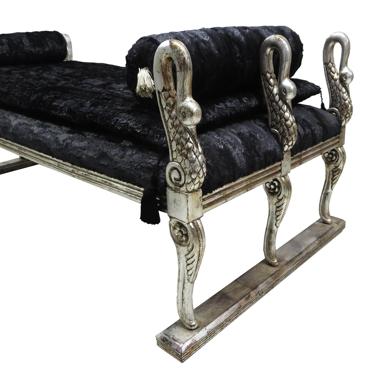 This magnificent 1920s Black Swan Daybed is perfect for your own Game of Thrones! The body of the bed is carved wood, with six exquisite swans. They have been finished in an antiqued silver leaf, to great effect. The bench has been re-upholstered in