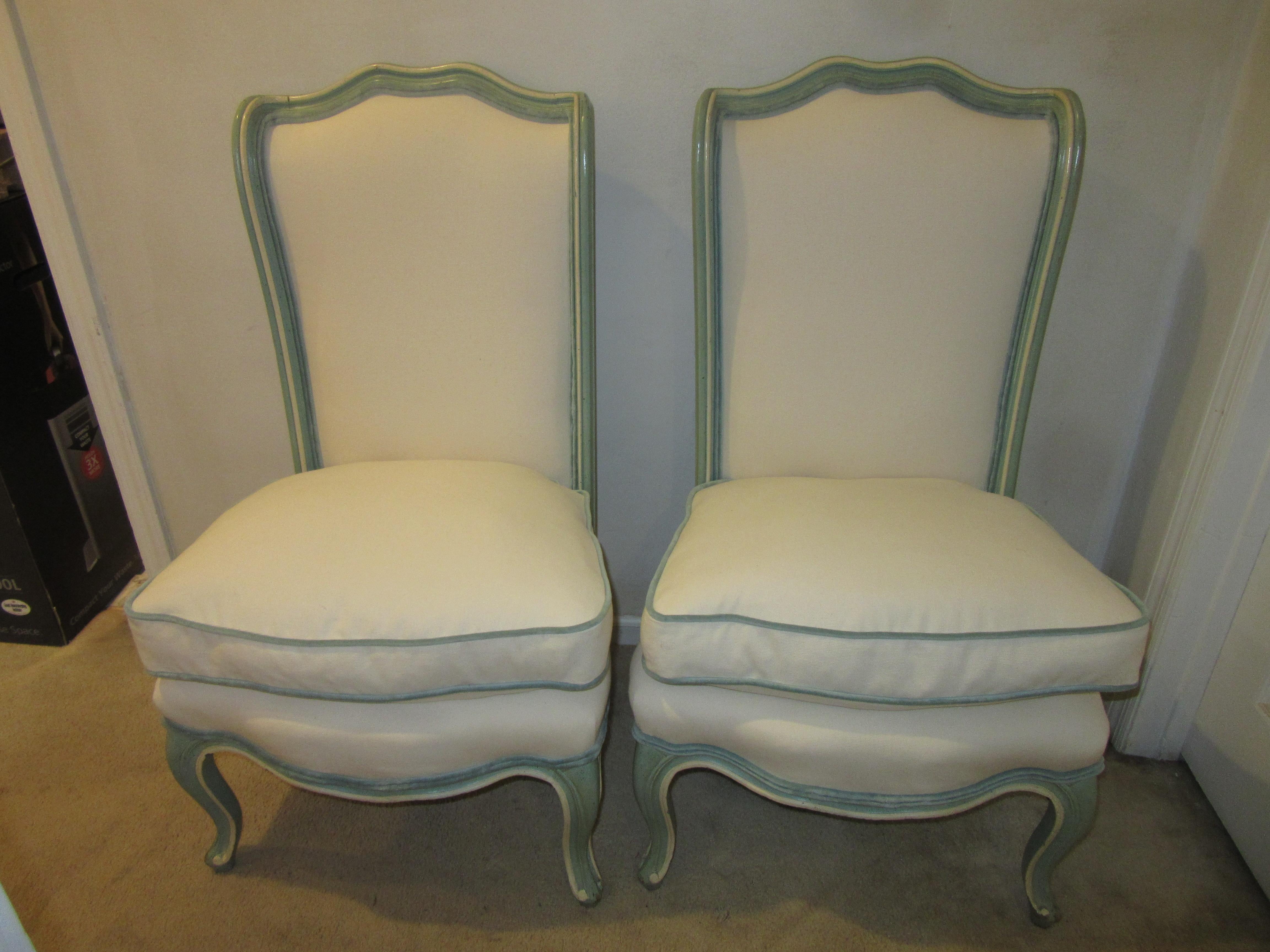 Hollywood Regency pair of robin's egg blue slipper chairs with white chenille upholstery, velvet cording, and matching leather backs. These chairs were recently reupholstered and are in very good vintage condition. There is some minor paint loss on