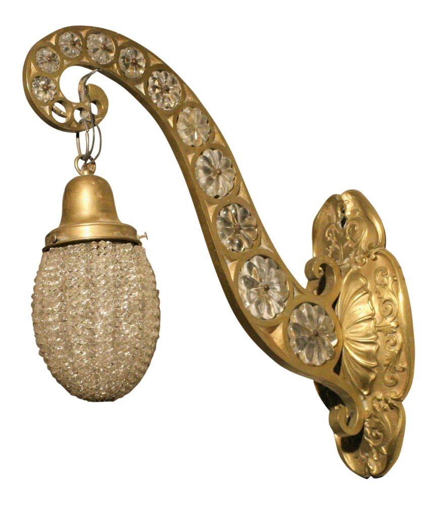 This unique pair of Hollywood Regency sconces is rendered in cast brass and embellished with crystal beading throughout.
 
Sold as a set of 2
Circa 1930 USA.
   