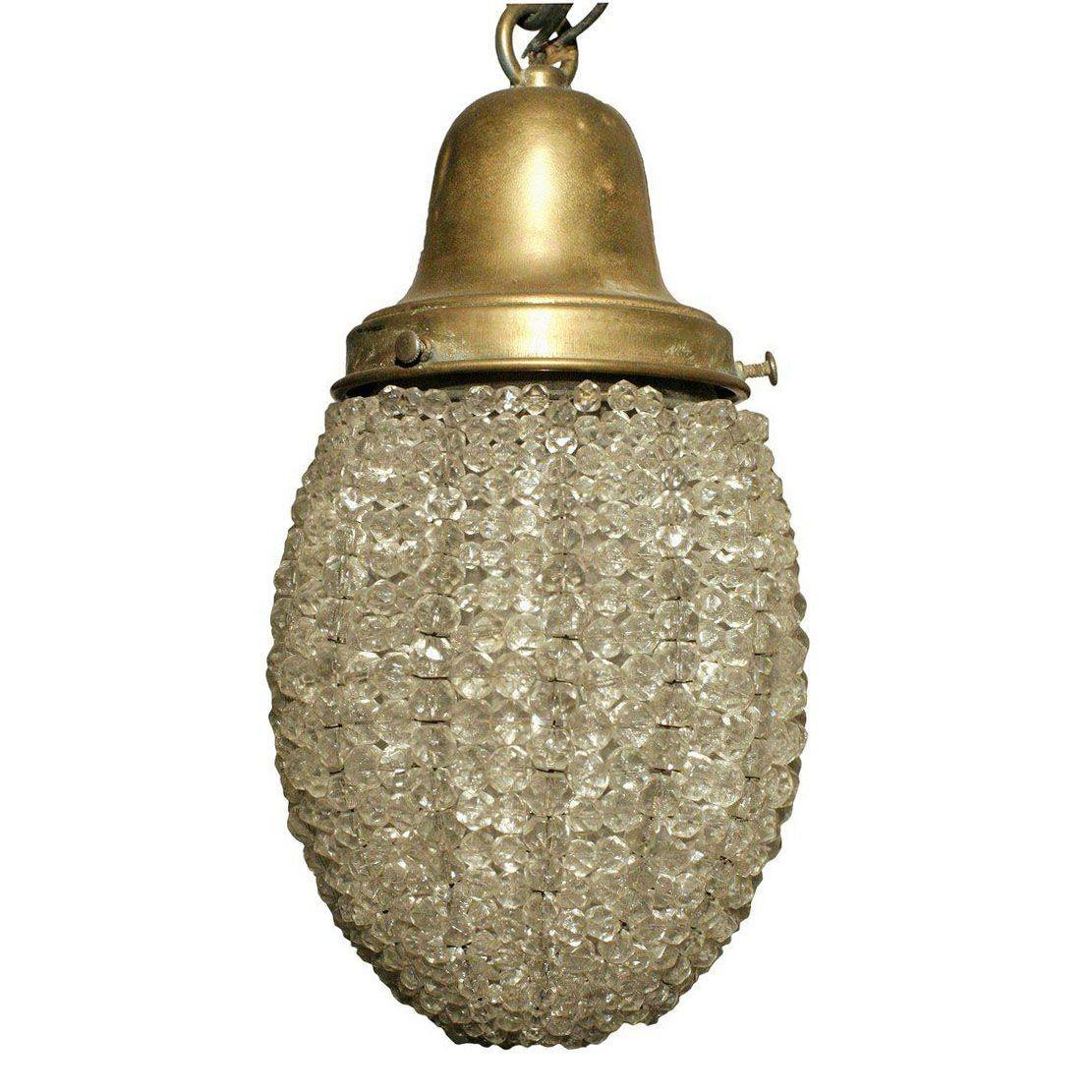 This unique Belle Epoque era Scrolling wall sconce is rendered in cast brass and embellished with crystal beading throughout. The light fixture features a beautifully curved scrolling arm adorned with decorative cut-outs revealing crystal along the